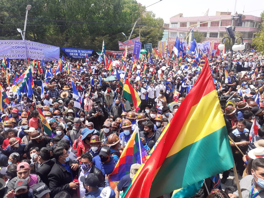 A large crowd waves Bolivian and Indigenous flags during the welcoming ceremony in Villazon, Bolivia
