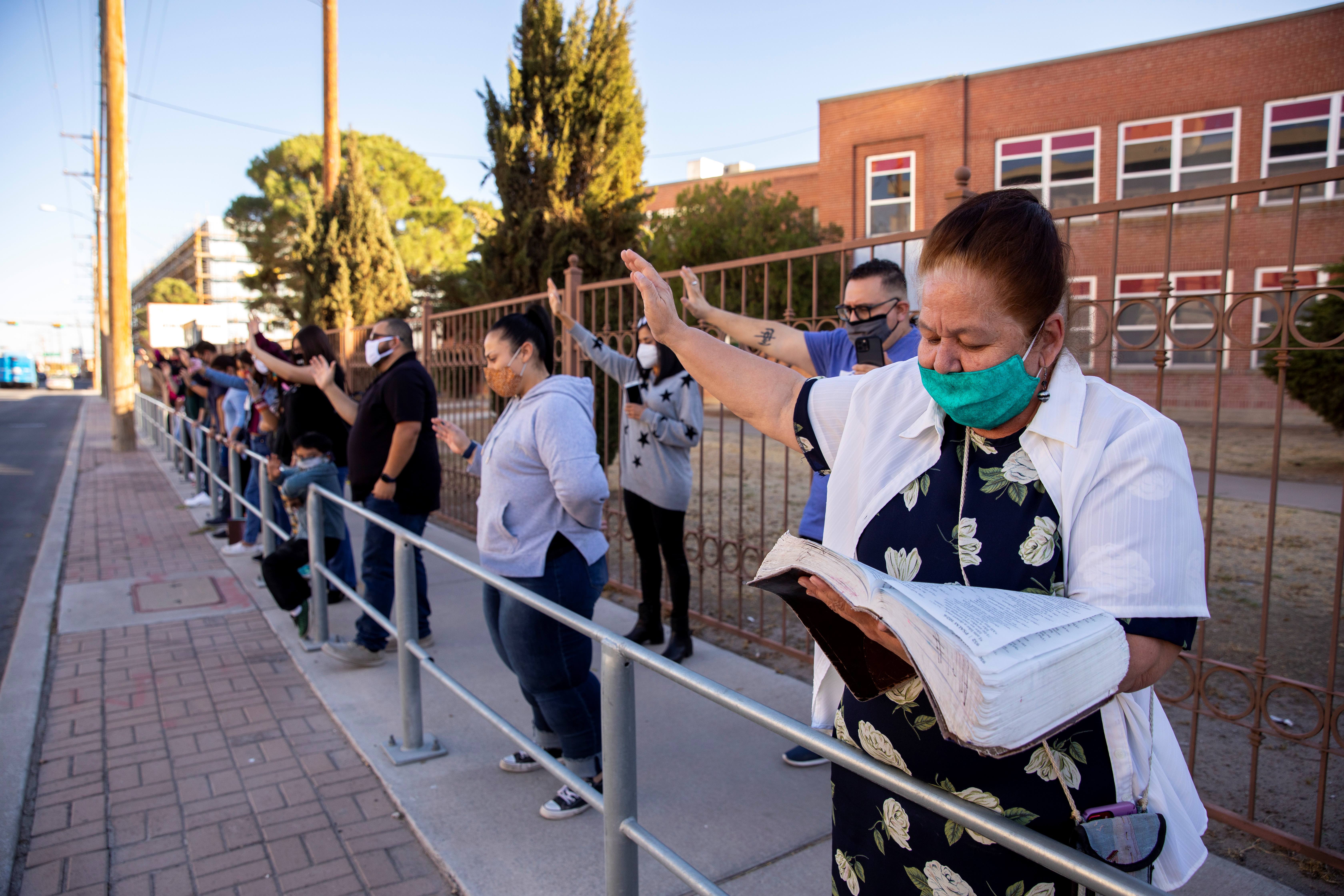 Members of Mesa Place Church pray outside University Medical Center of El Paso amid the coronavirus outbreak, in El Paso, Texas, the United States