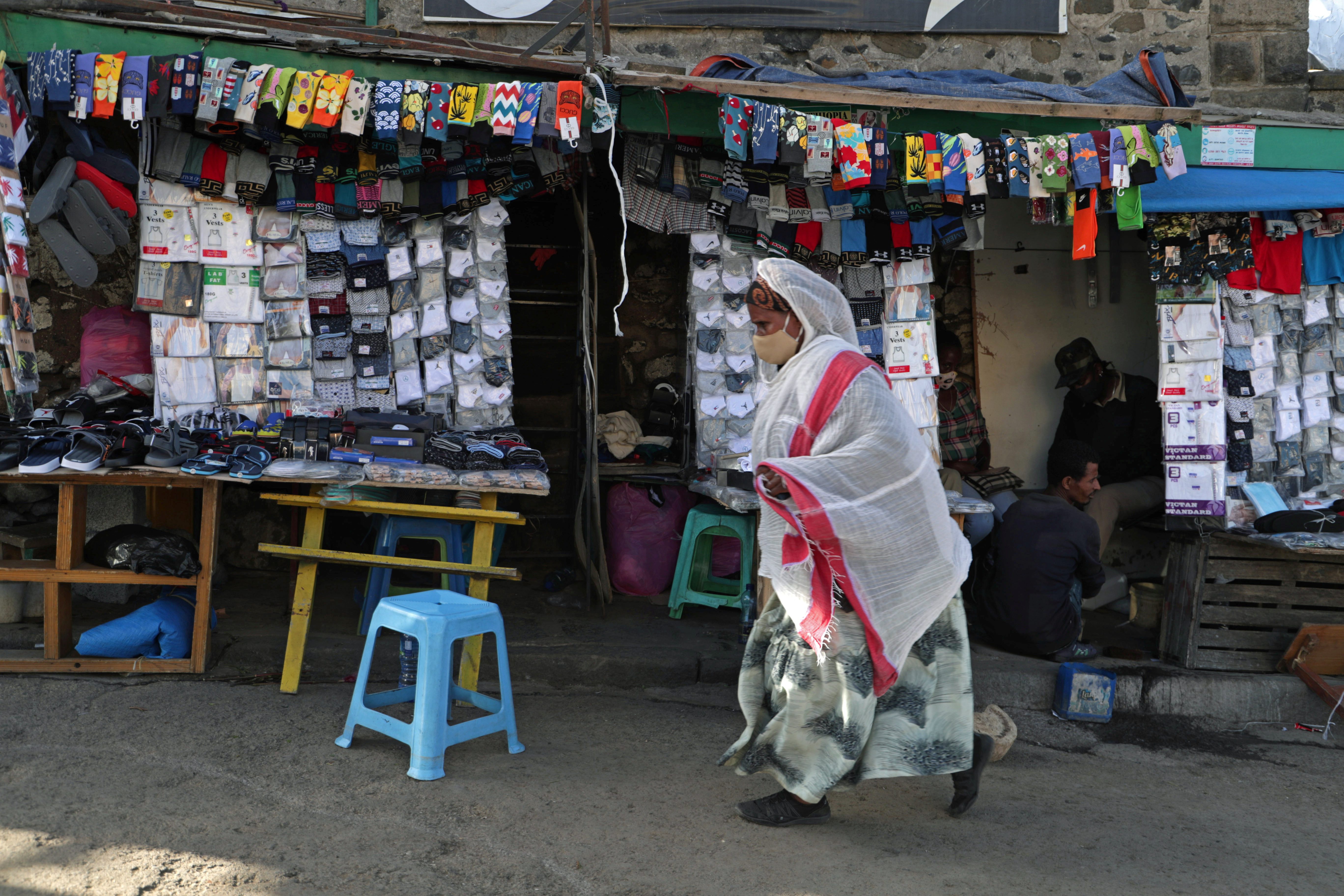 A woman walks next to a fashion boutique in Piassa neighbourhood of Addis Ababa, Ethiopia