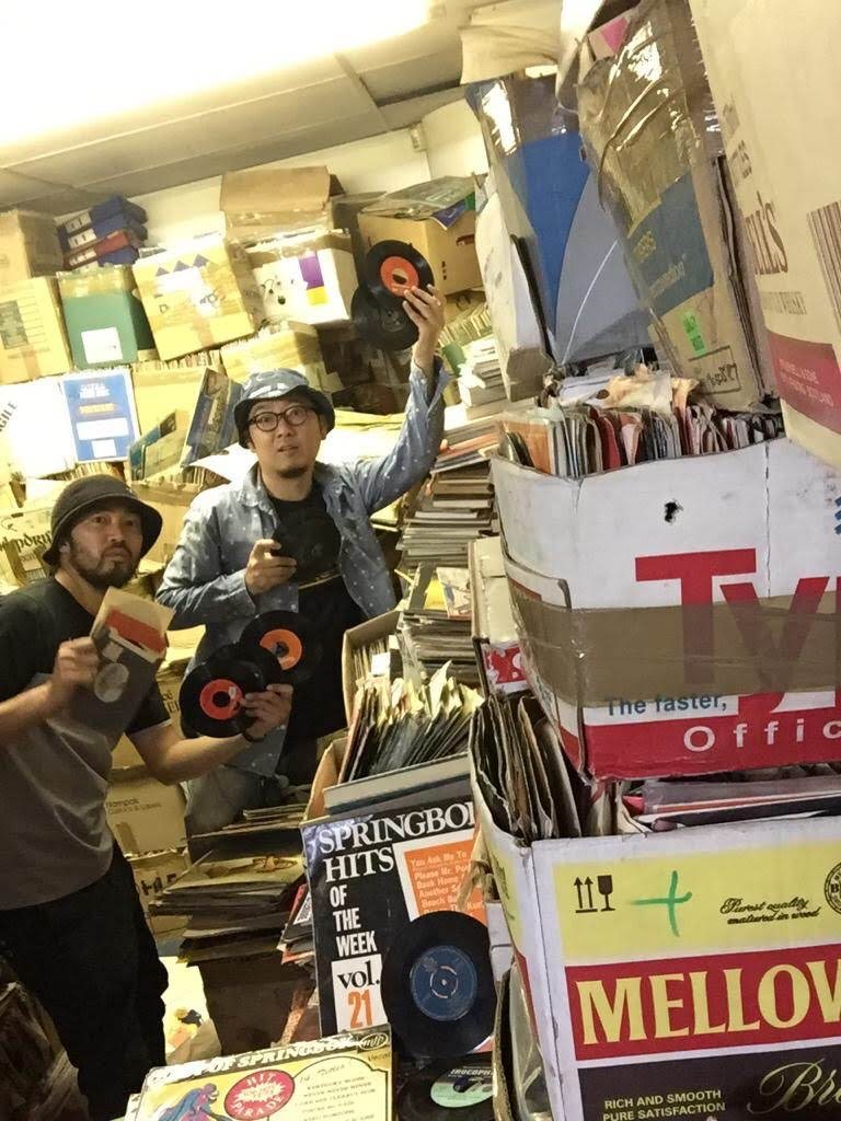 Jun and a friend dig for records at a thrift store in Johannesburg [Photo courtesy of Jun Morikawa]
