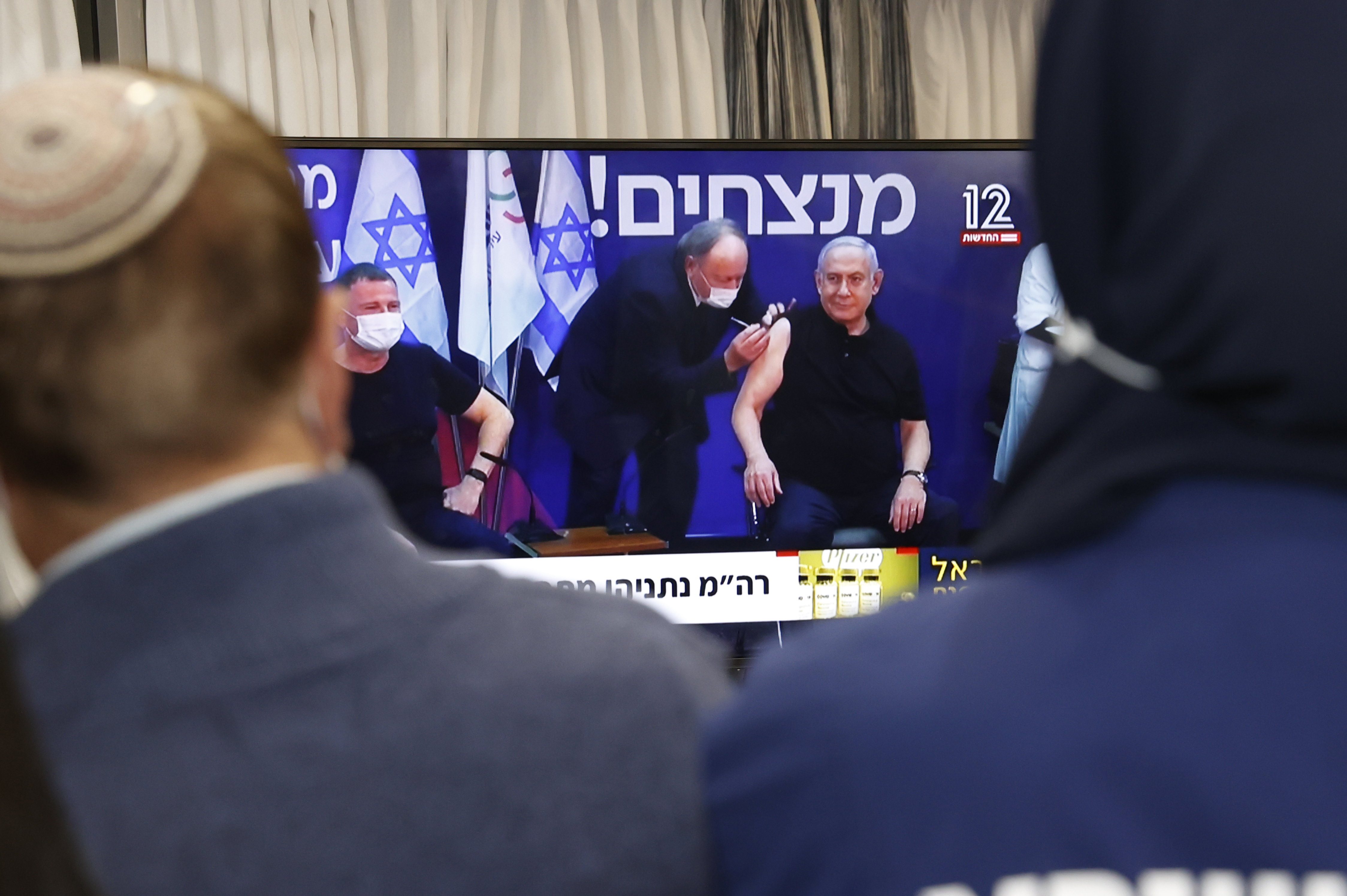 Netanyahu, right, and Edelstein, left, are injected with the Pfizer-BioNTech vaccine live on TV