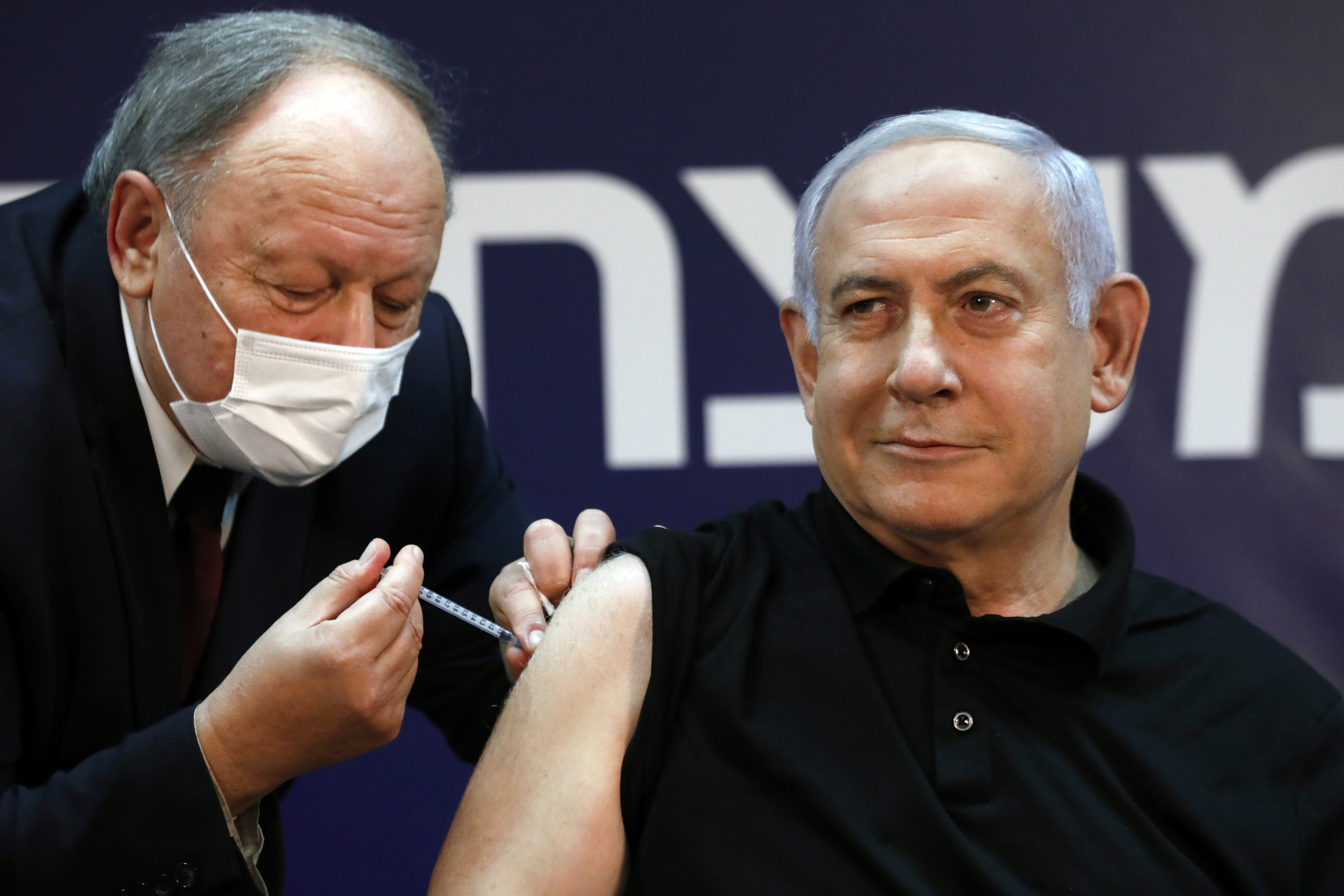 Israeli Prime Minister Benjamin Netanyahu receives a coronavirus vaccine in December [Amir Cohen via AFP]