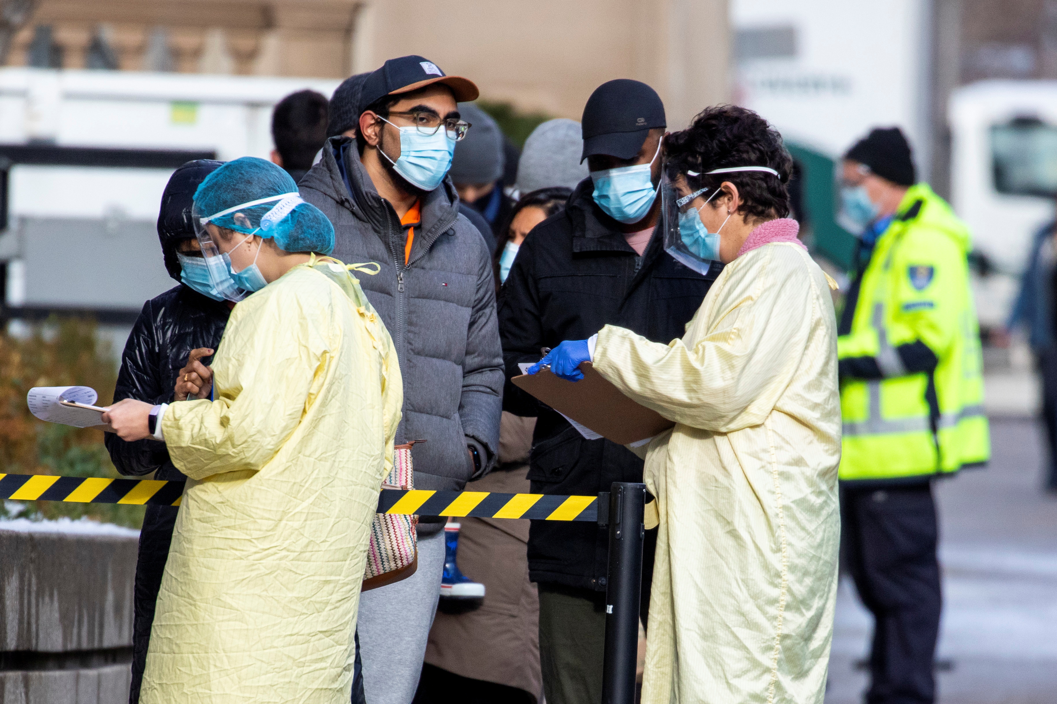 People wait in line to get a COVID-19 test at Mount Sinai Hospital in Toronto as the city entered renewed COVID-19 lockdown in late November
