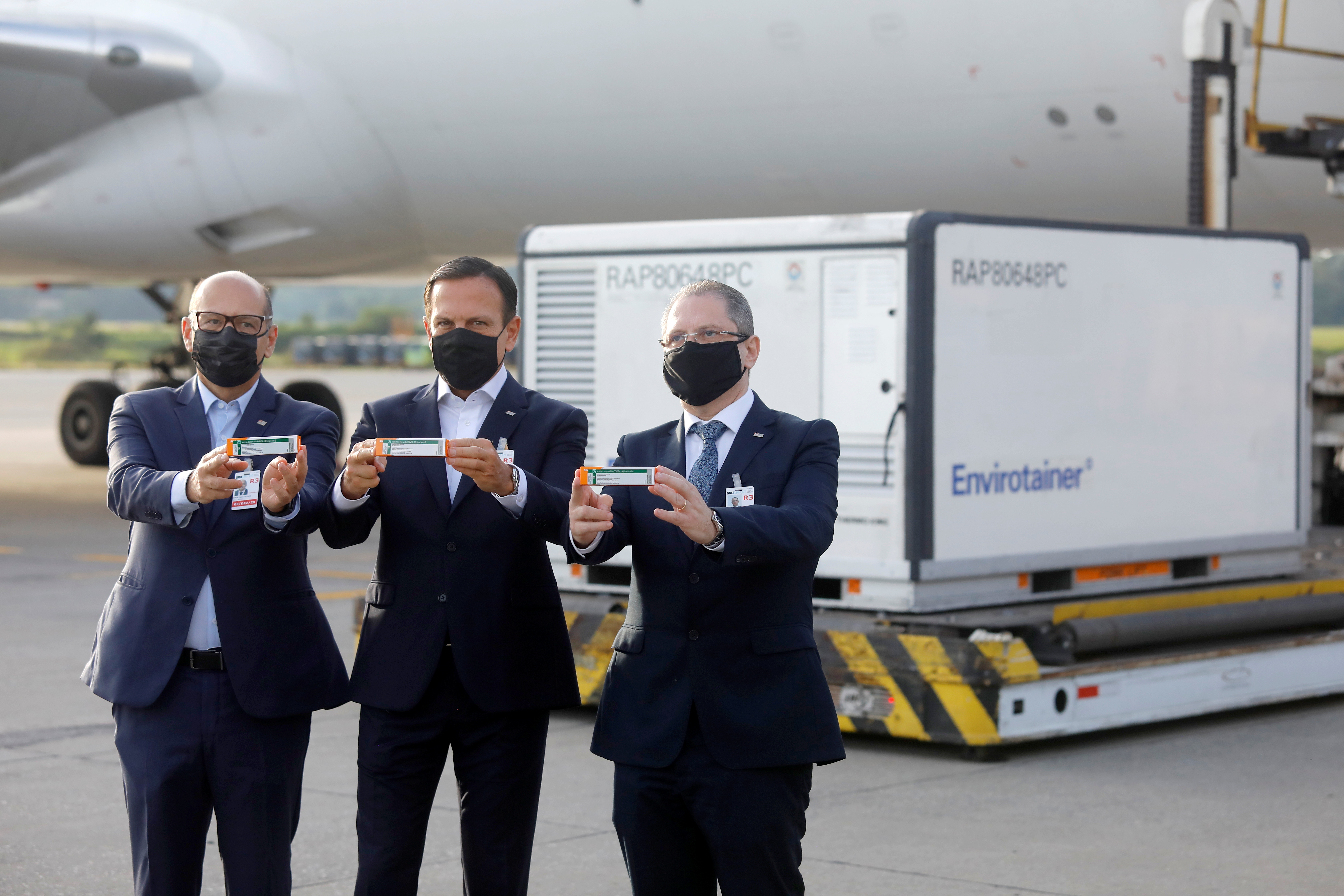 Brazil’s Sao Paulo state governor Joao Doria, director of Instituto Butantan Dimas Tadeu Covas and Health Secretary Jean Gorinchteyn welcome the arrival of 600 litres (158 gallons) of the CoronaVac vaccine at Guarulhos International airport in Sao Paulo