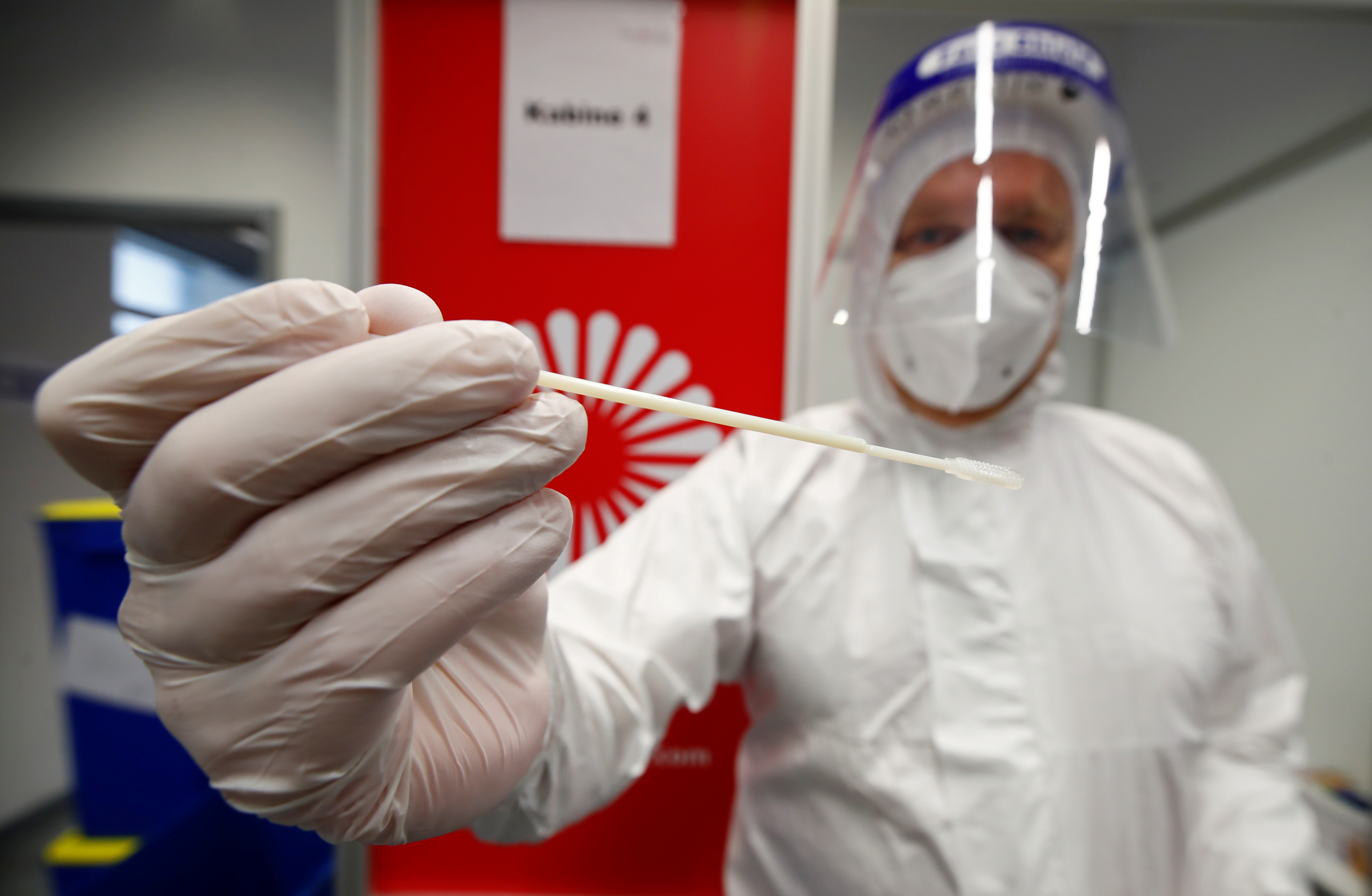 A medical worker collects a swab sample in the COVID-19 testing centre at Duesseldorf Airport, as EU countries impose a travel ban from the UK following the coronavirus disease (COVID-19) outbreak