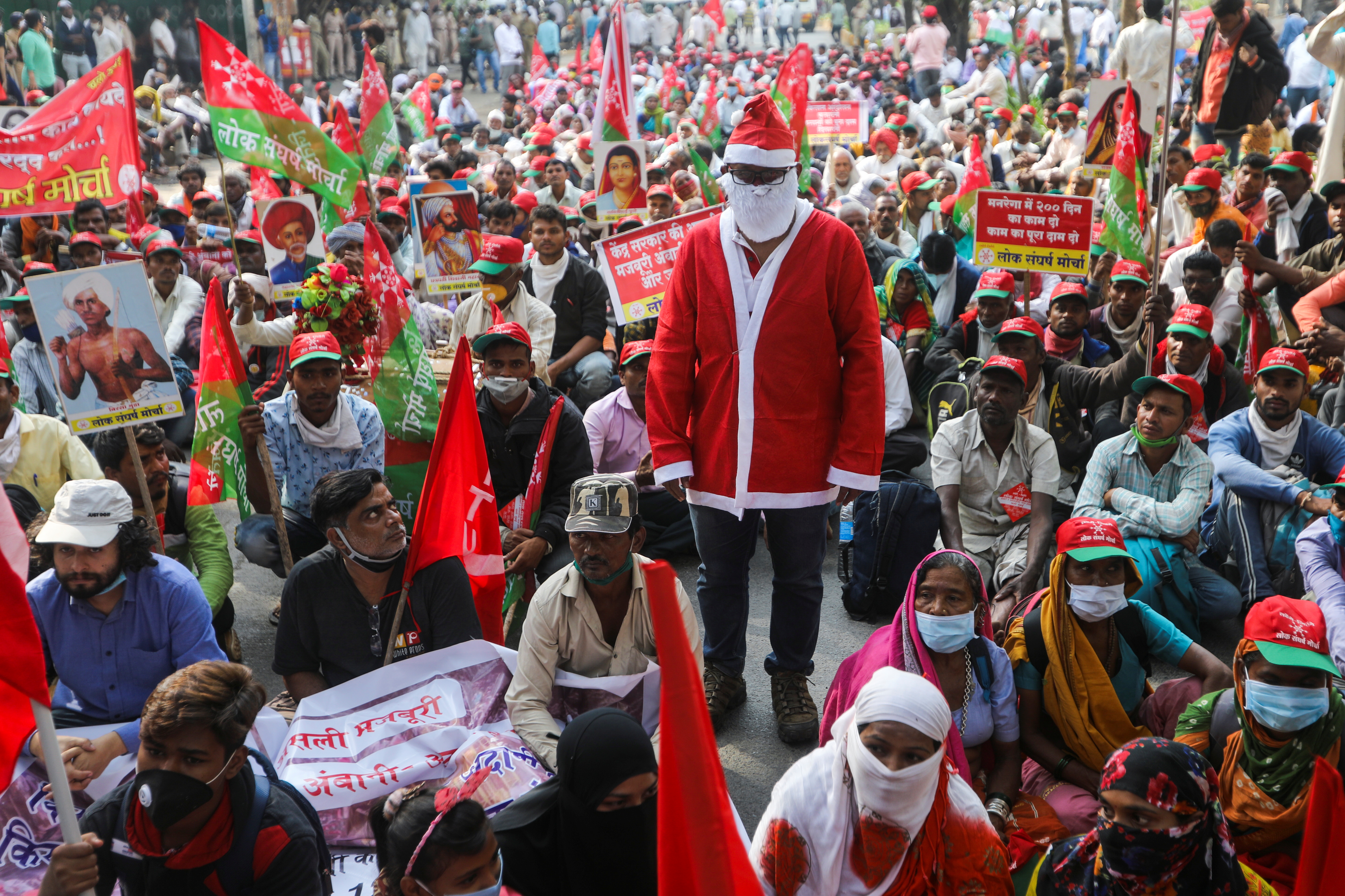A man dressed as Santa Claus stands amid farmers and members of various agricultural organisations during a protest in Mumbai
