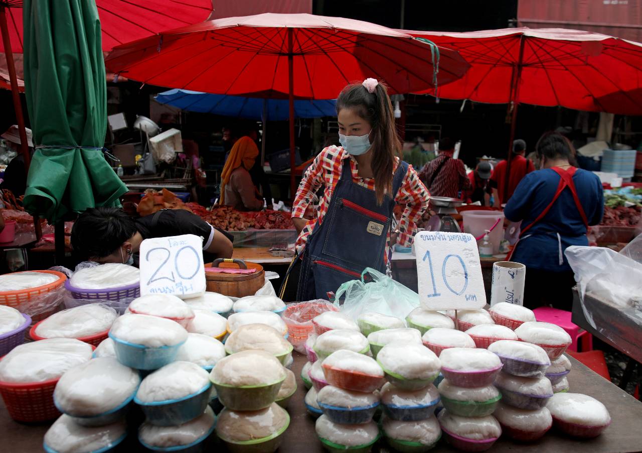 A migrant worker from Myanmar work at a street market in Bangkok amid the pandemic