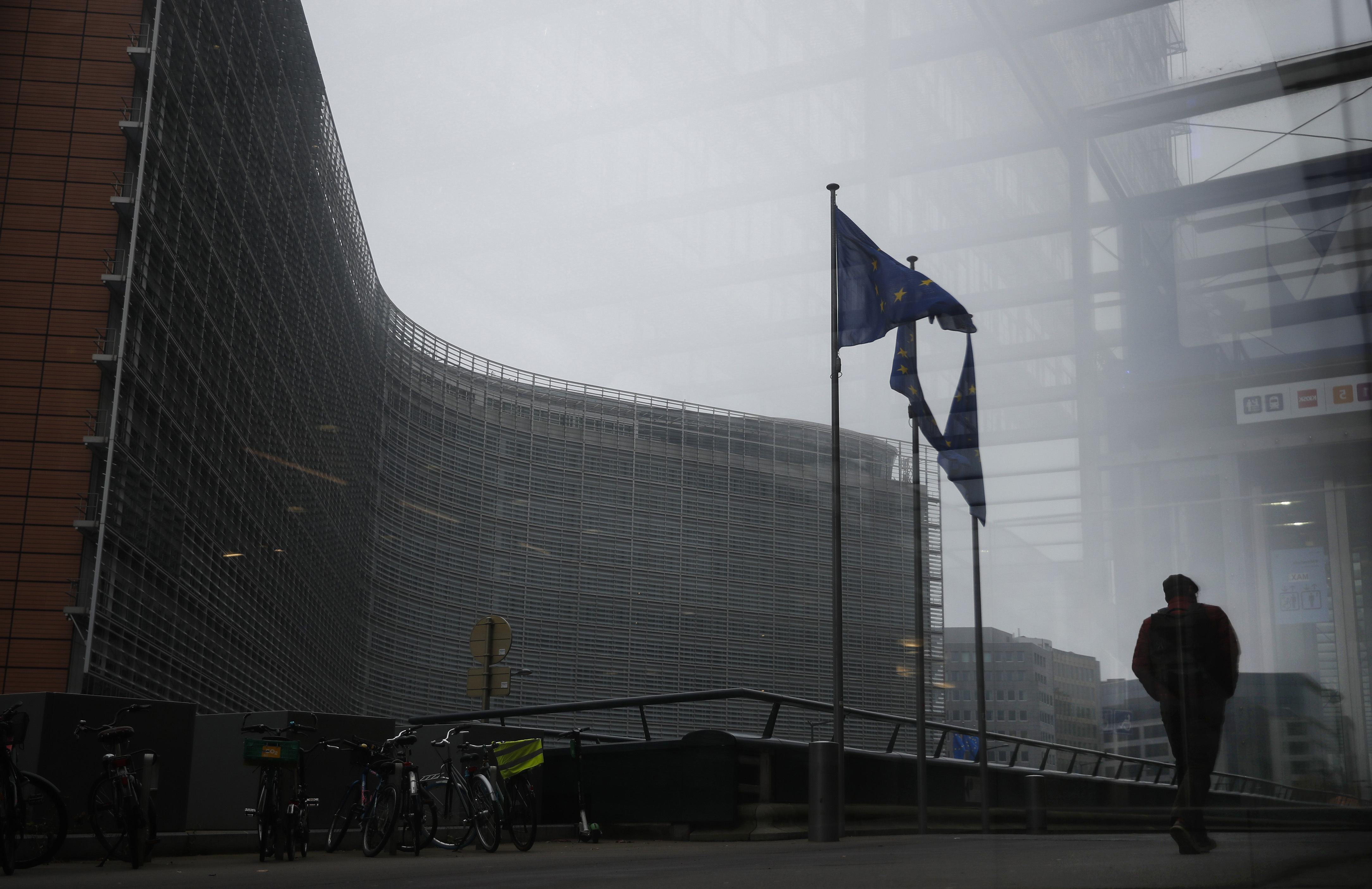 A pedestrian walks past the European Commission headquarters in Brussels, where British Prime Minister Boris Johnson is travelling to try and find a way through the impasse on Brexit talks