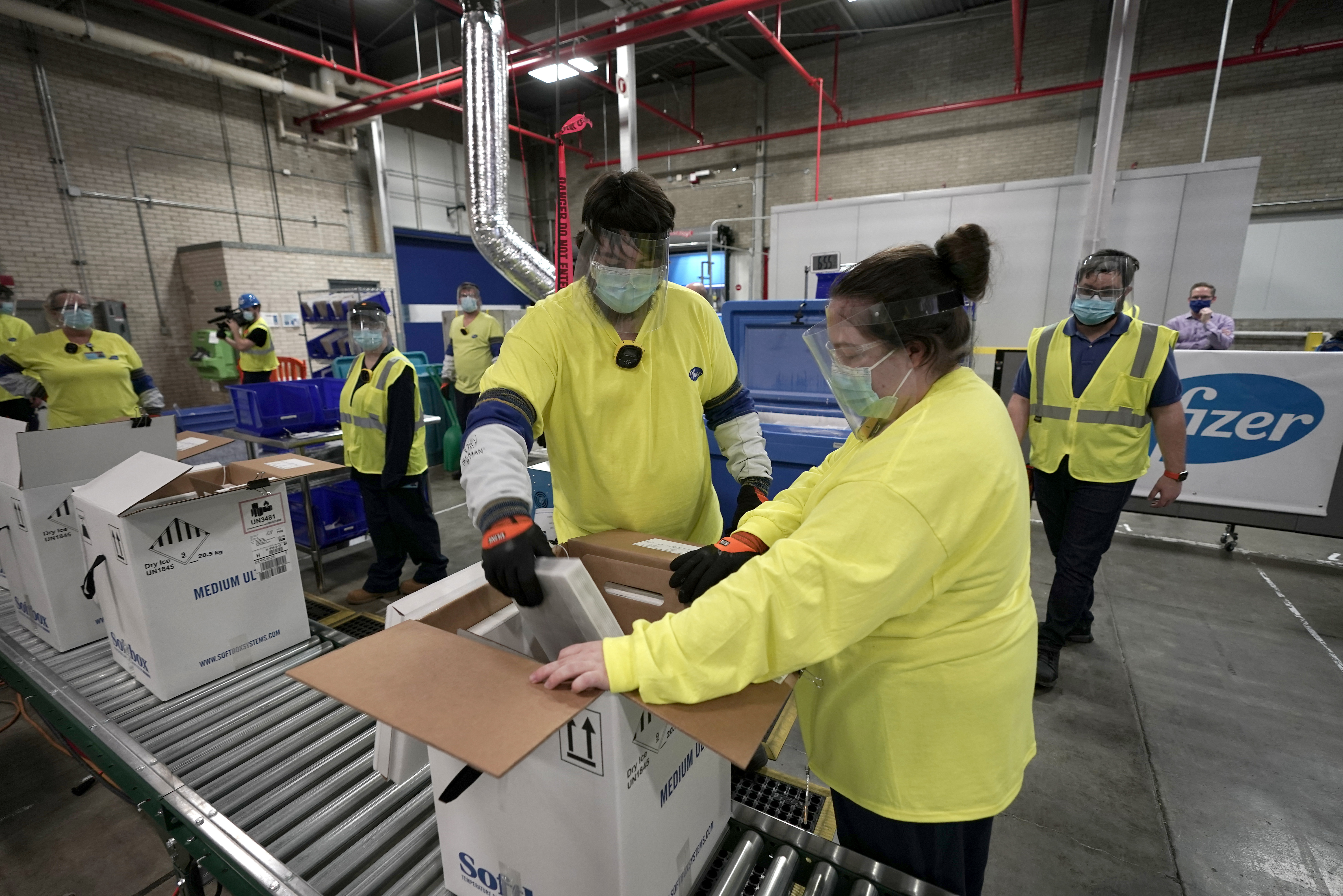 Boxes containing the Pfizer-BioNTech COVID-19 vaccine are prepared to be shipped at the Pfizer Global Supply Kalamazoo manufacturing plant in Portage, Michigan