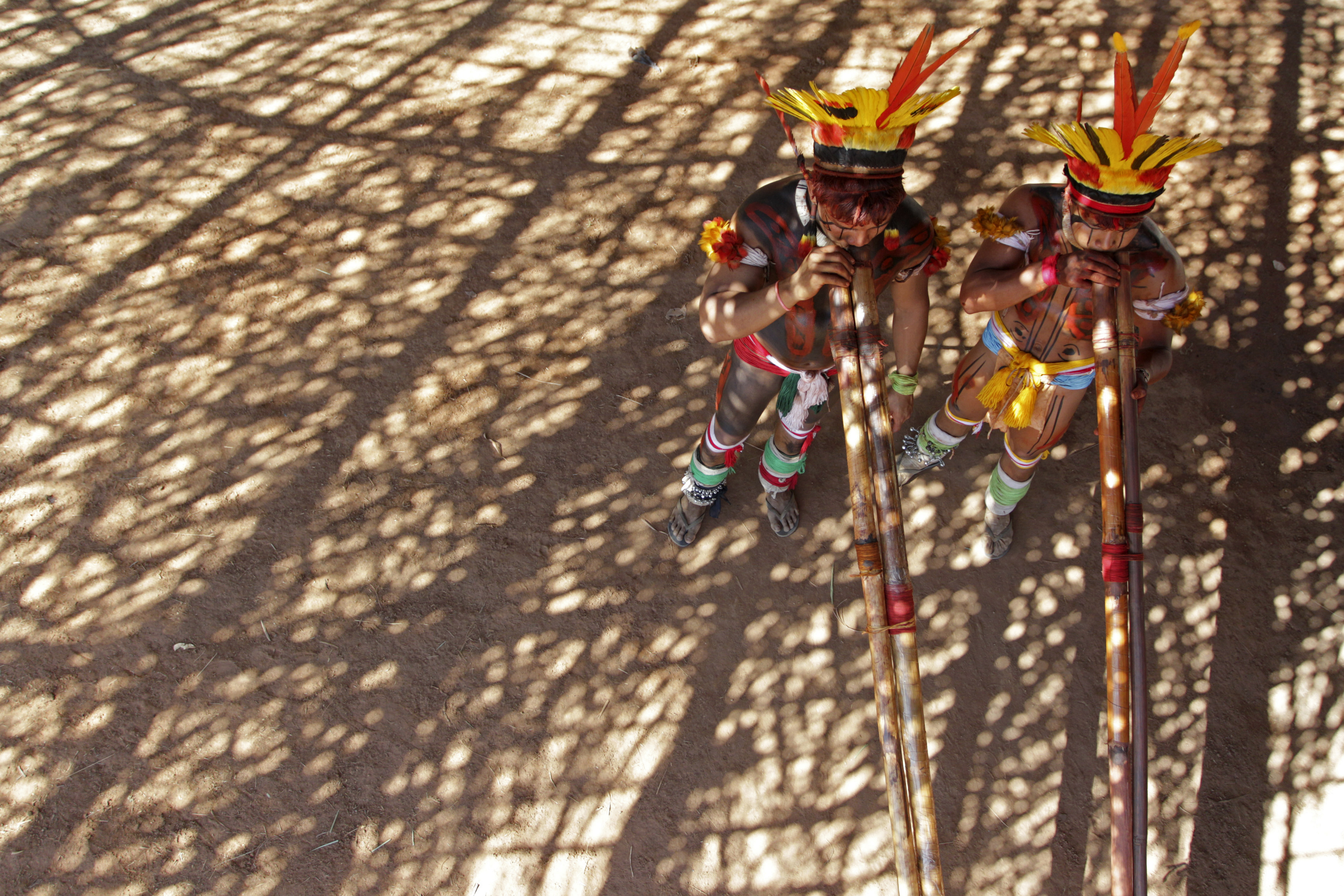 Yawalapiti men play bamboo flutes during ‘quarup,’ a ritual held to honour in death a person of great importance to them, in Xingu