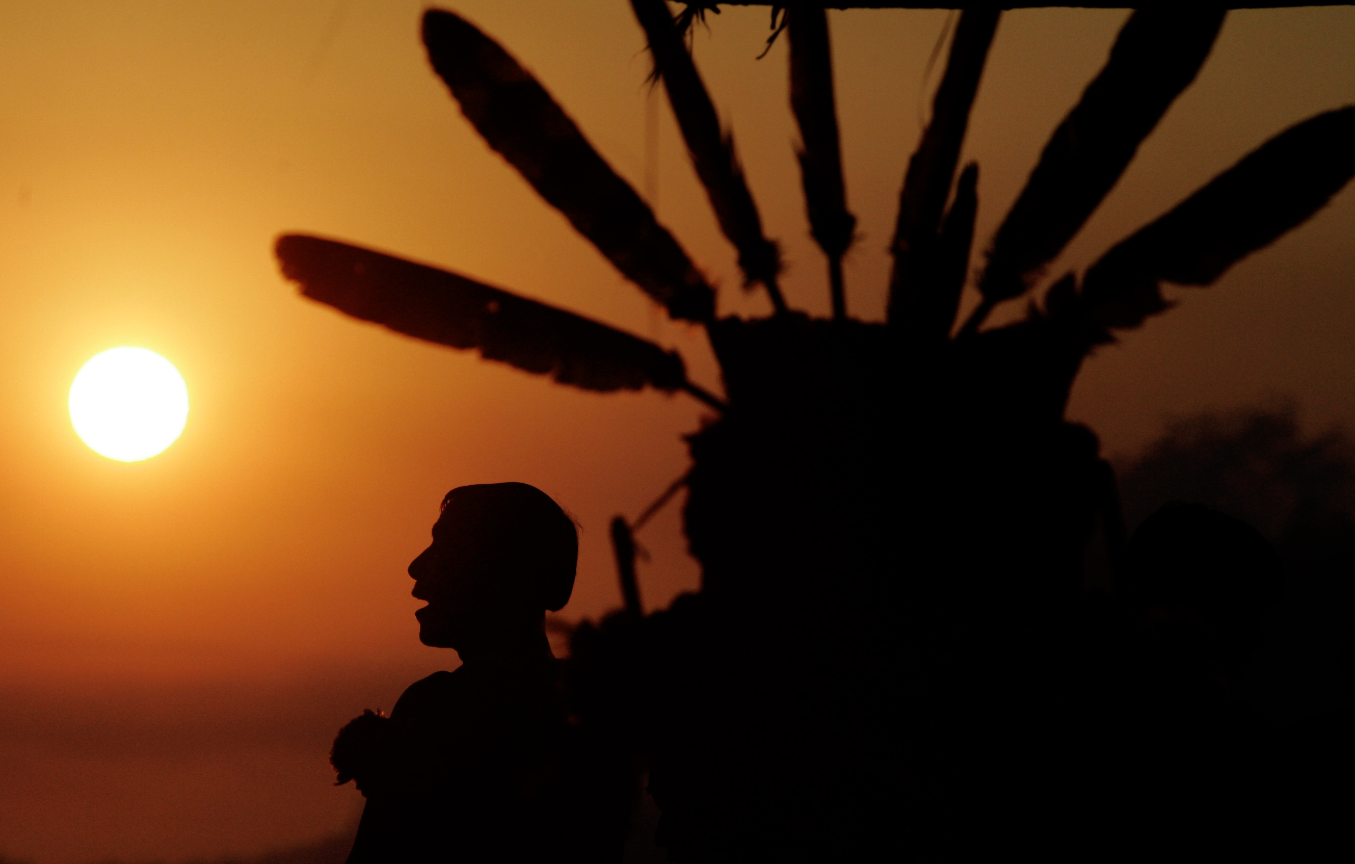 A Waura tribesperson seen at sunrise at the Quarup festival of the dead in Xingu