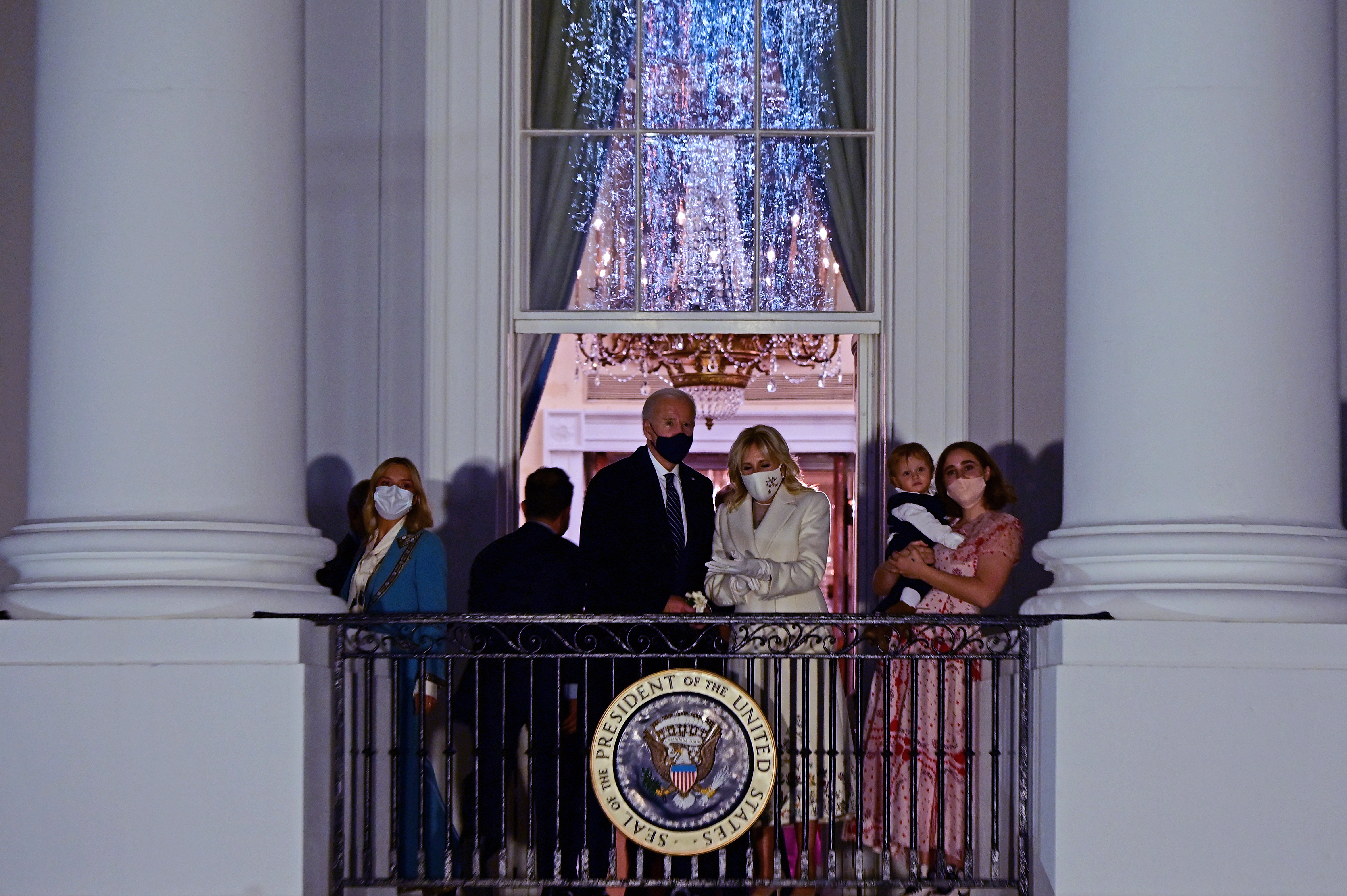 US President Joe Biden and First Lady Jill Biden watch the fireworks from the balcony of the Blue Room with their wider family