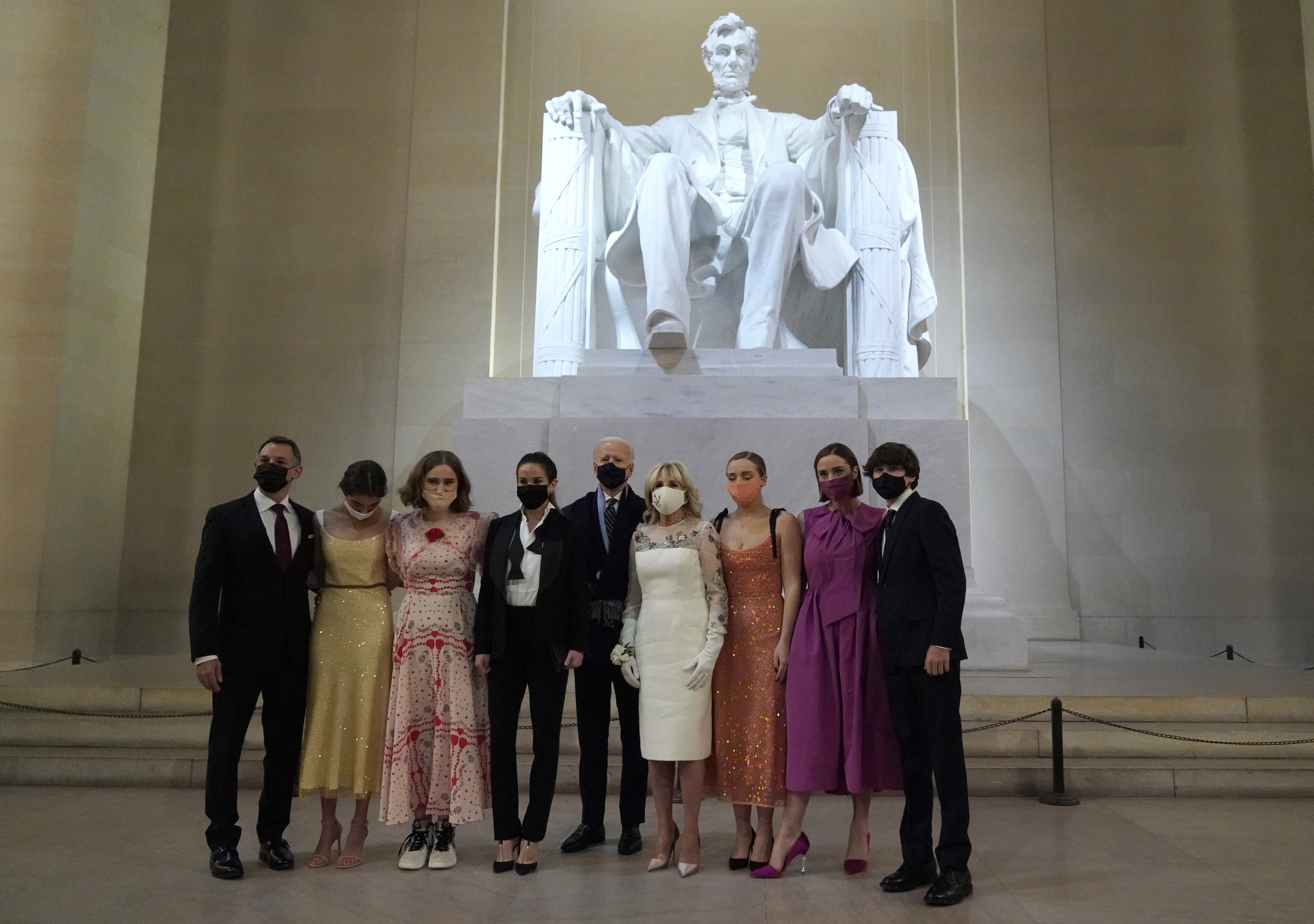 Biden and First Lady Jill Biden pose with their family in front of the statue of Abraham Lincoln at the “Celebrating America” event at the Lincoln Memorial after his inauguration