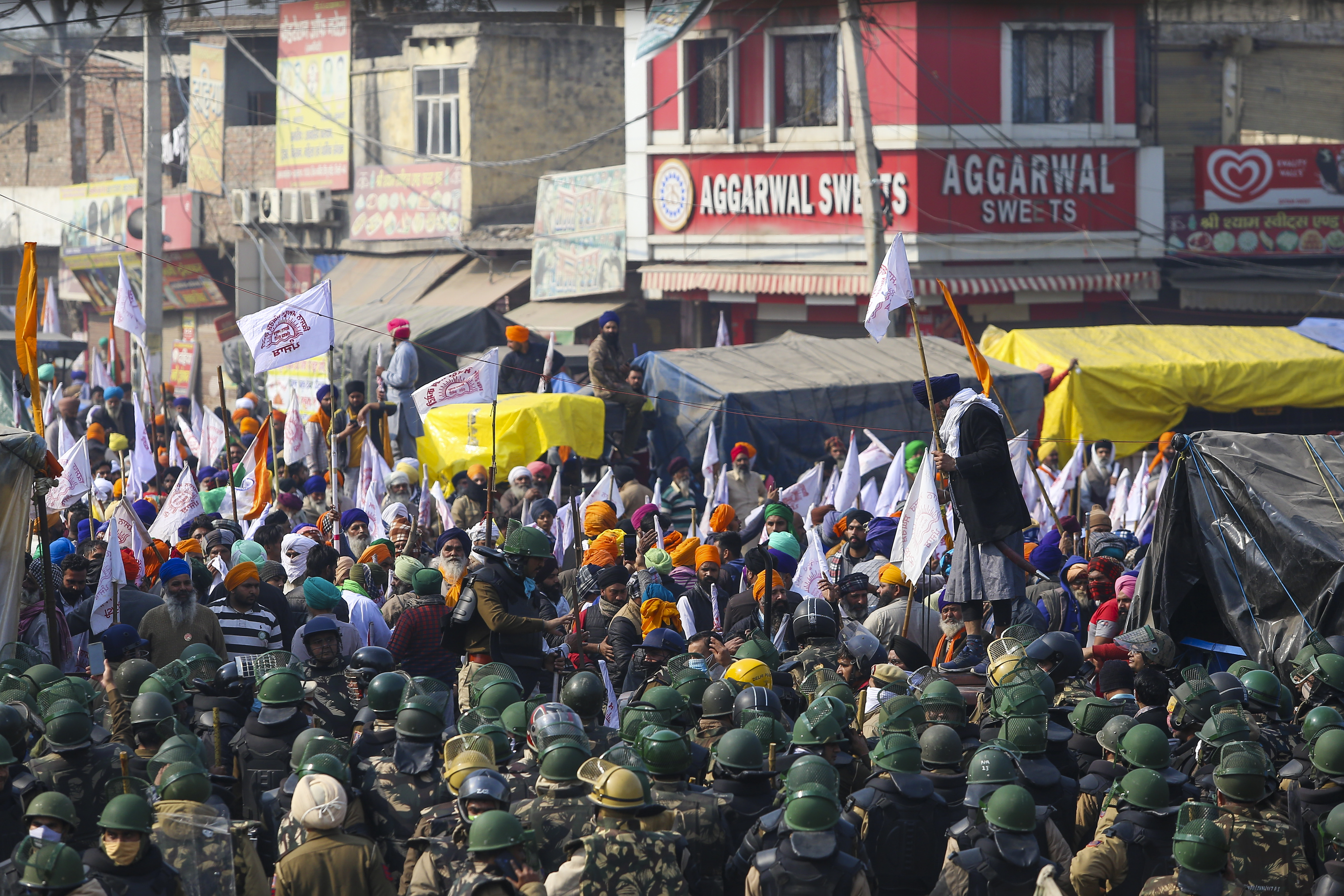 Security personnel stand guard as farmers continue their protest in Singh