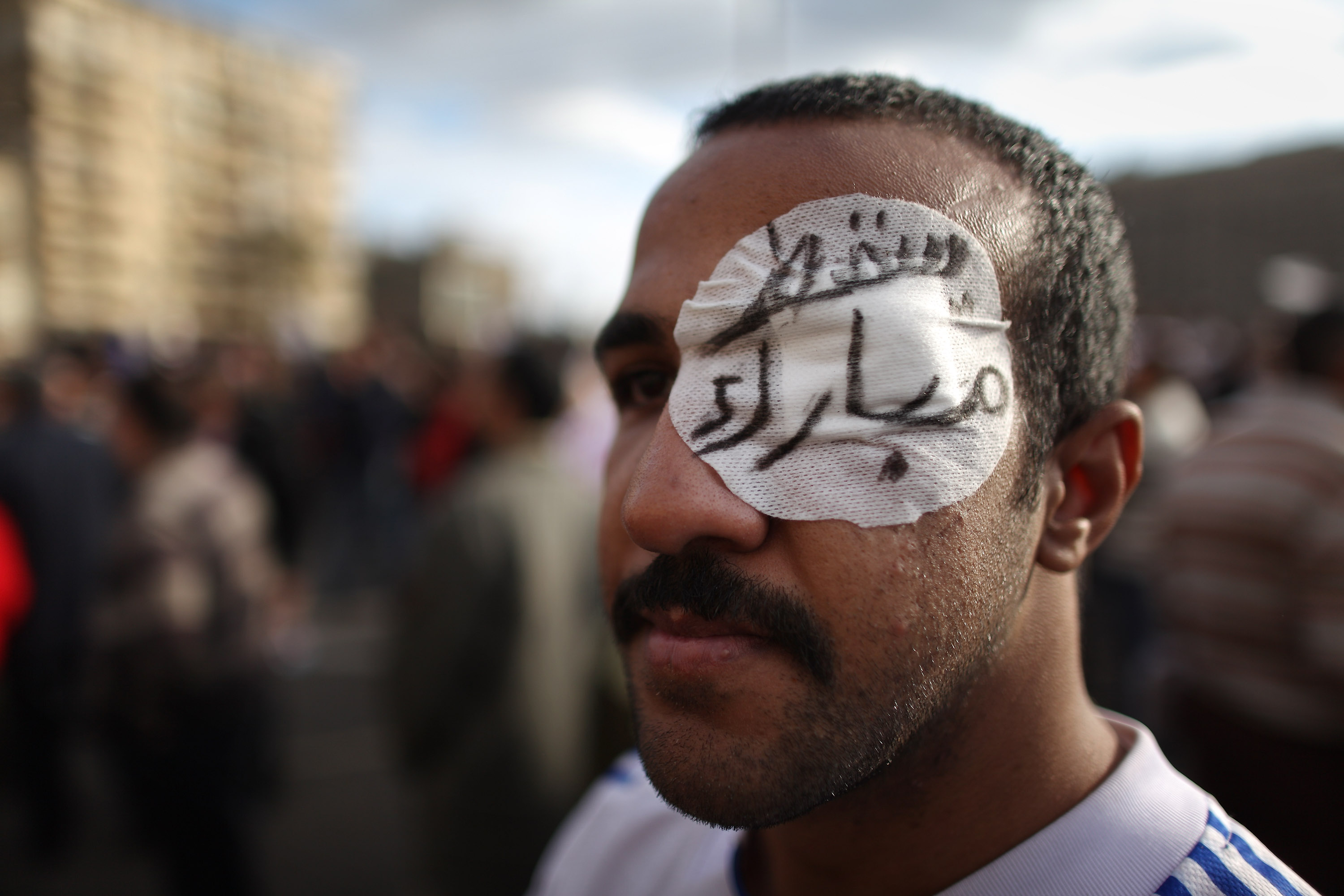 A protestor with an eye bandage saying ‘Go Mubarak’ in Arabic stands in Tahrir Square on January 31, 2011 in Cairo, Egypt