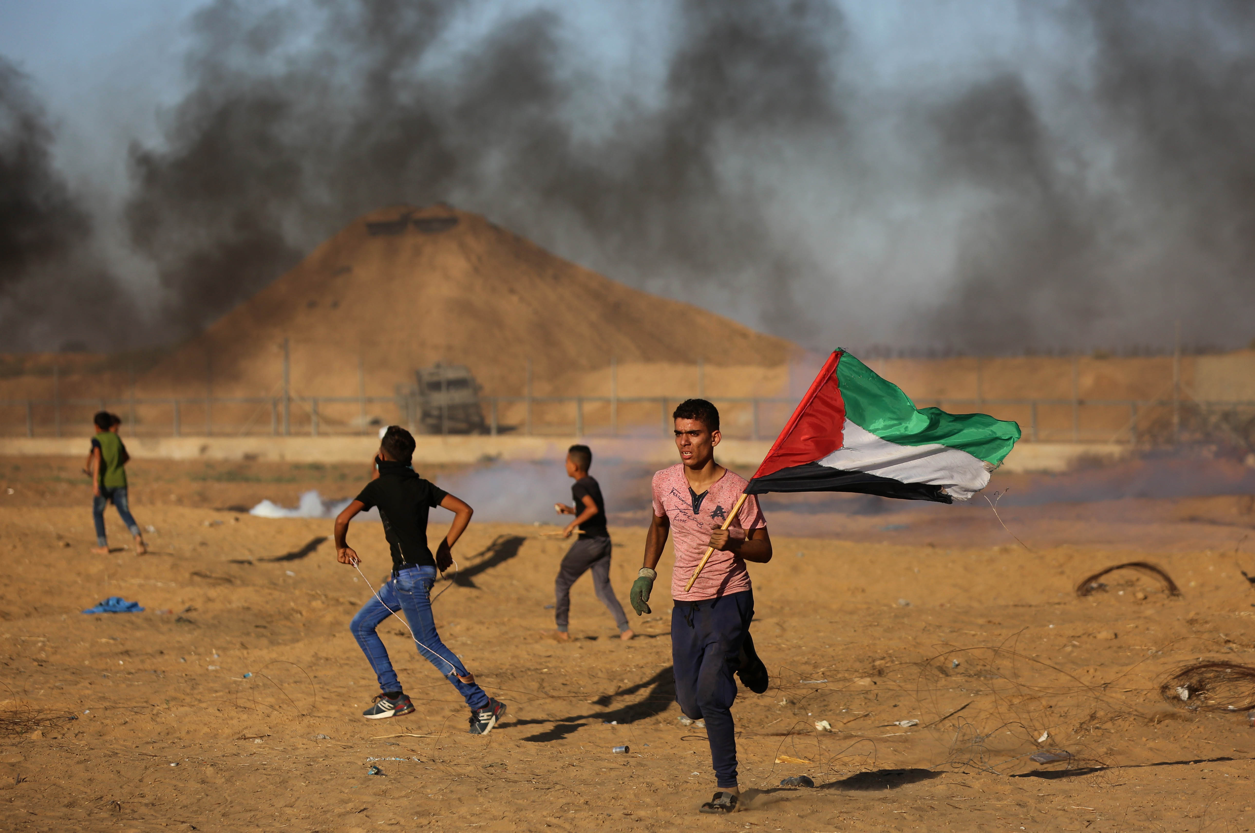 Palestinian protesters face tear gas during a ‘Great March of Return’ demonstration near Gaza’s border in Khan Yunis, Gaza on October 4, 2019