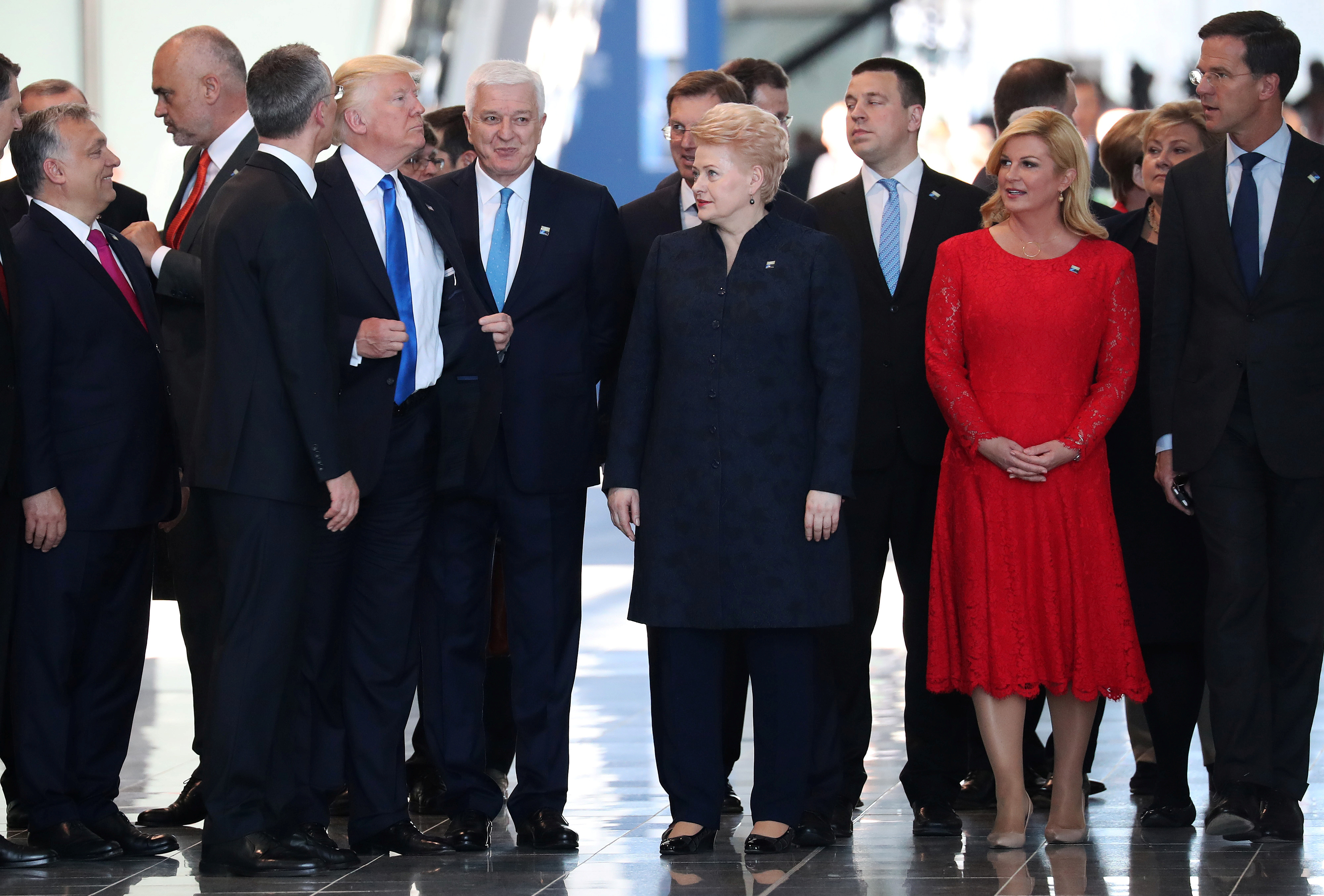 President Donald Trump adjusts his jacket after pushing past Montenegro Prime Minister Dusko Markovic at the NATO Summit in Brussels, Belgium, May 25, 2017
