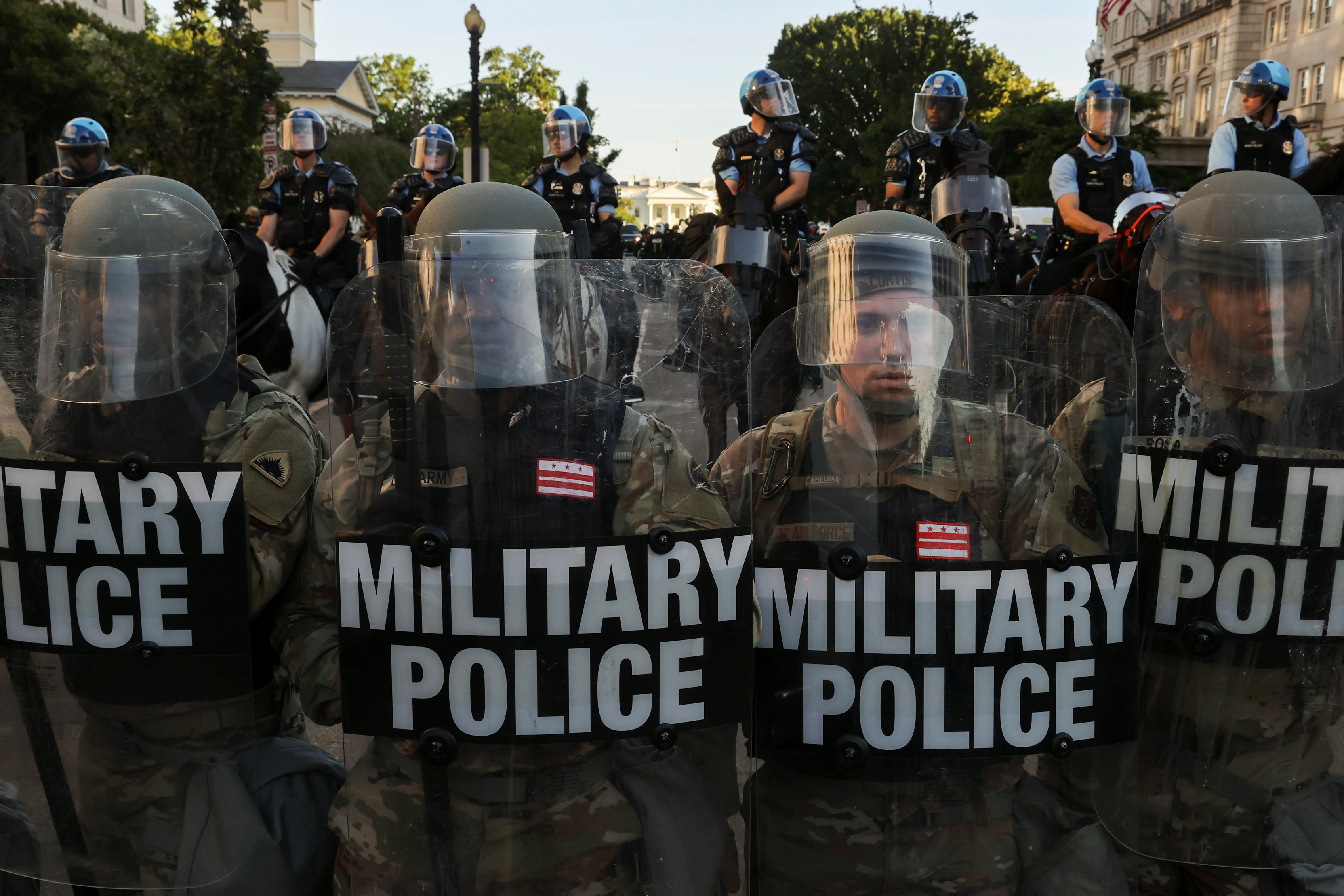DC National Guard Military Police officers and law enforcement officers line up during a protest against the death of George Floyd, near the White House in Washington, DC
