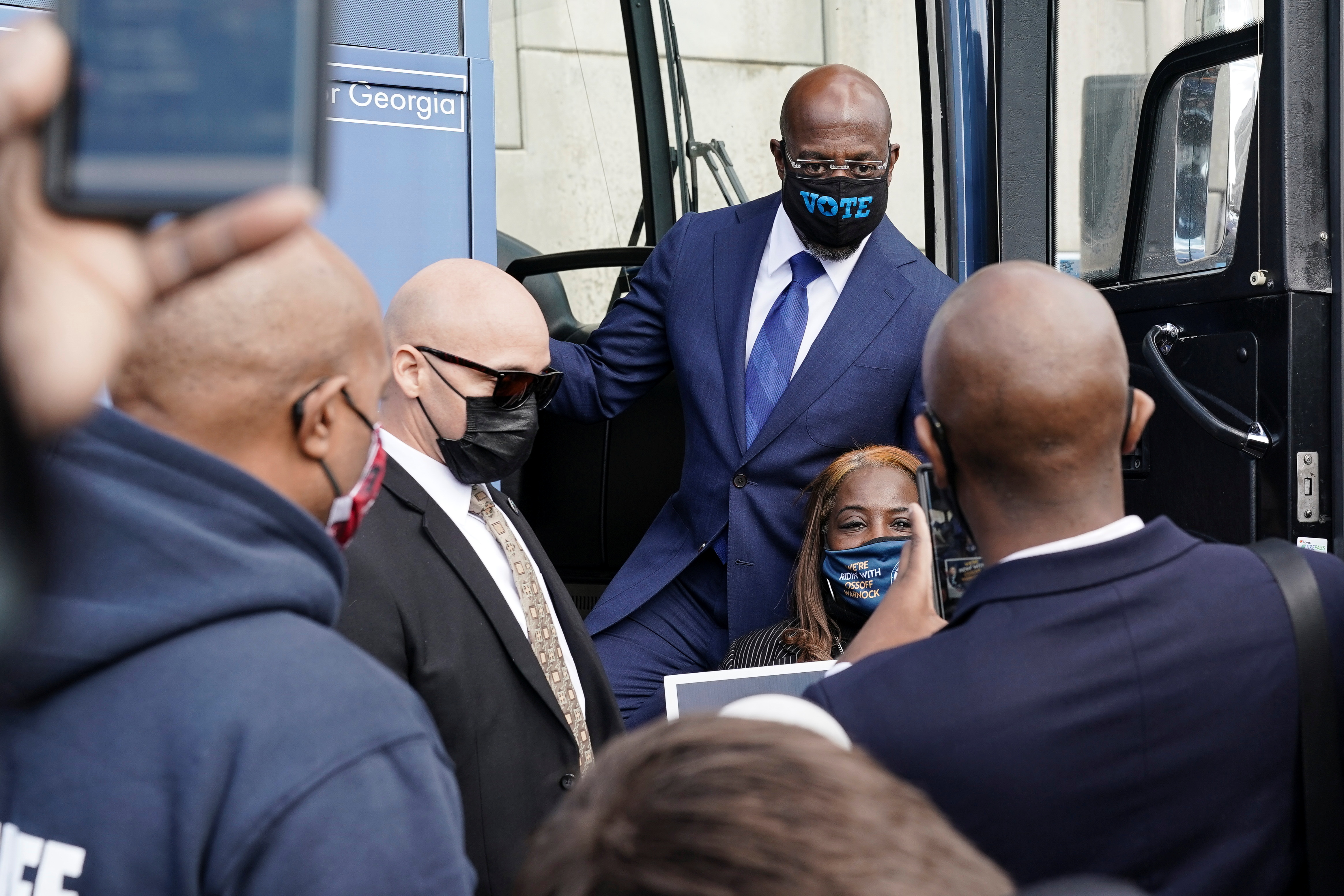 Democratic US Senate candidate Raphael Warnock takes a photo with a supporter in Atlanta, Georgia, January 5, 2021