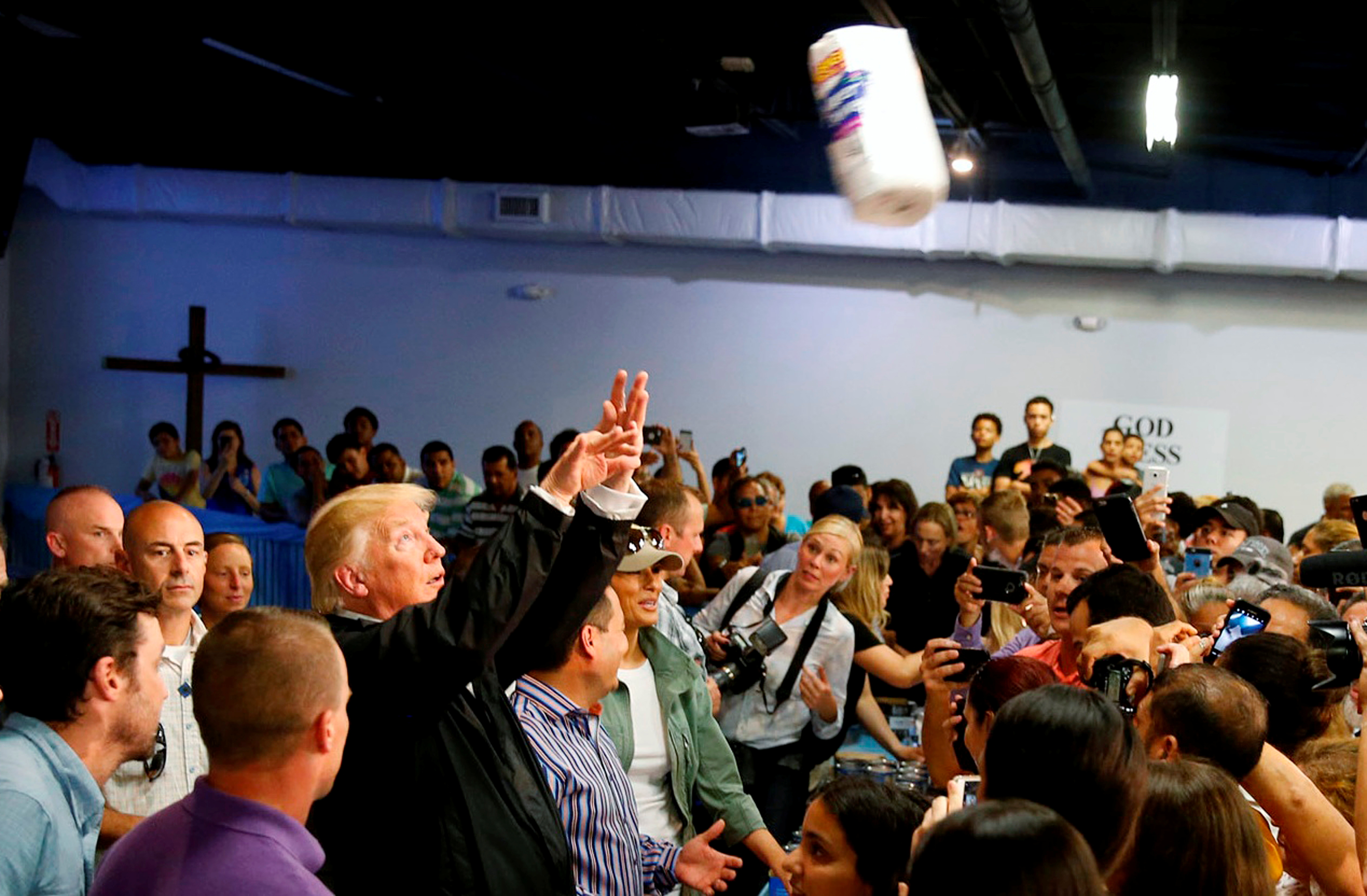 President Donald Trump throws rolls of paper towels into a crowd of residents affected by Hurricane Maria in San Juan, Puerto Rico, October 3, 2017