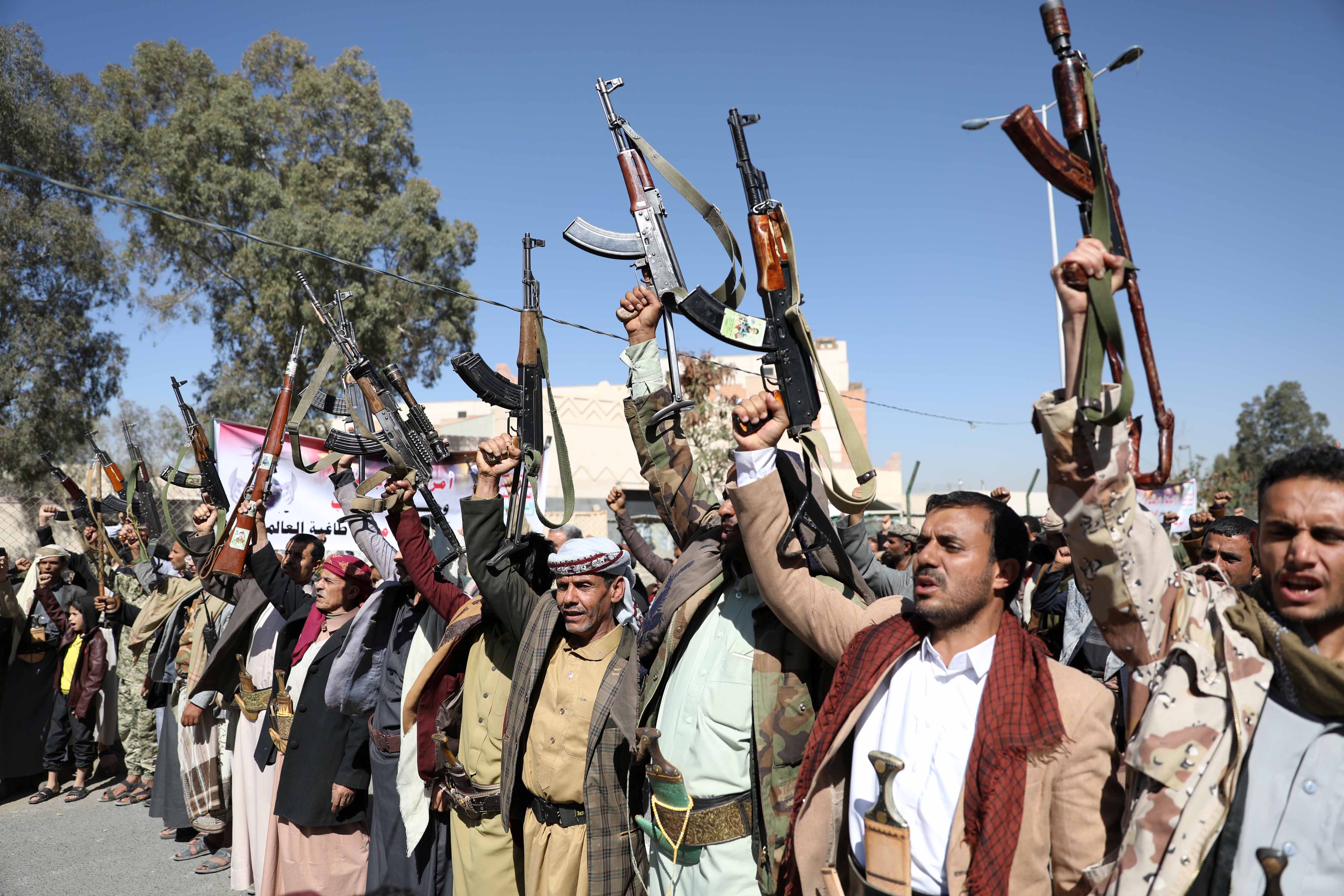 Houthi supporters hold up their weapons during a demonstration outside the US embassy against the US decision to designate the Houthis a foreign terrorist organisation in Sanaa, Yemen on January 18, 2021 [Reuters/Khaled Abdullah]