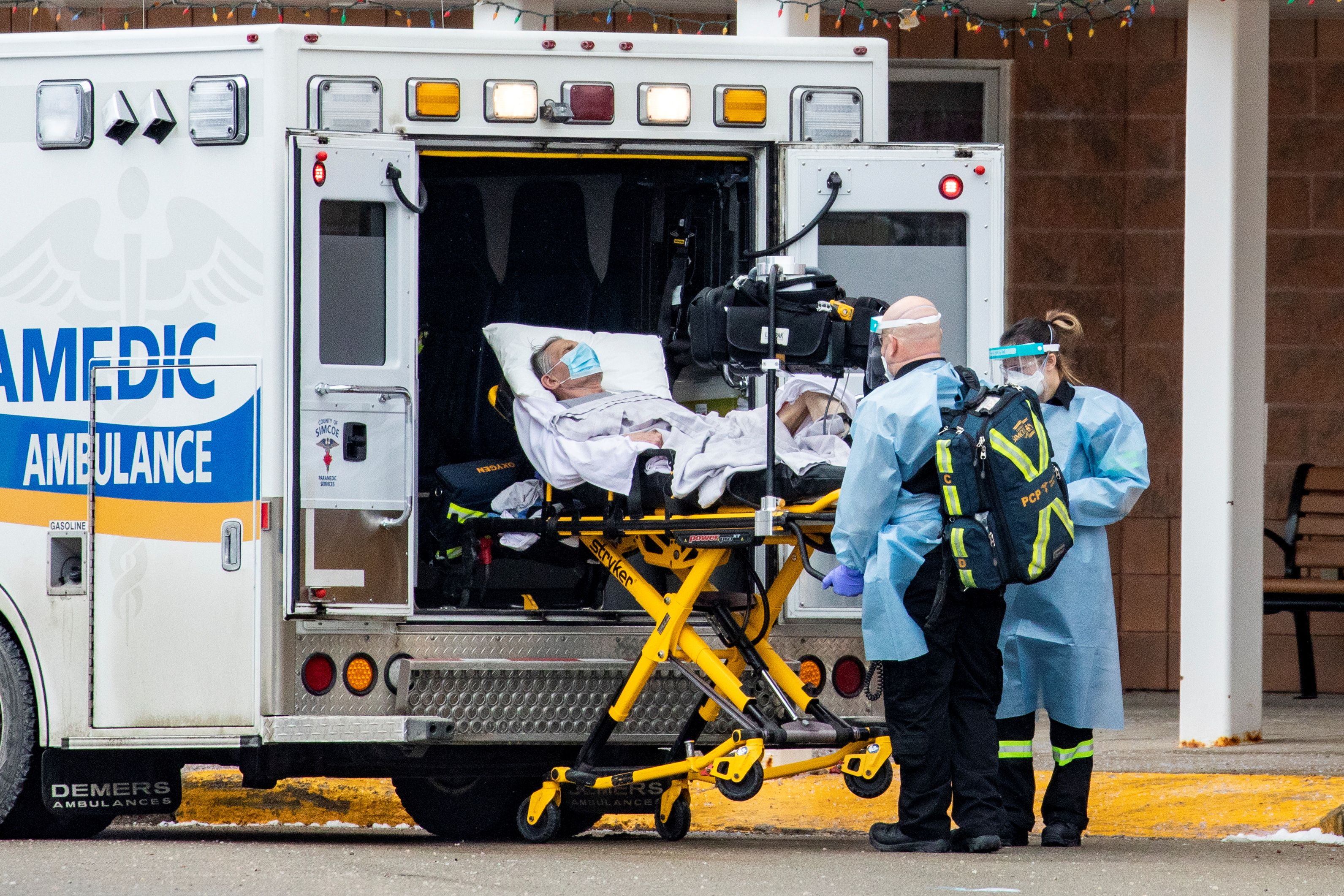 Paramedics transport a person from Roberta Place, a long-term seniors care facility which is the site of a COVID-19 outbreak, in Barrie, Ontario