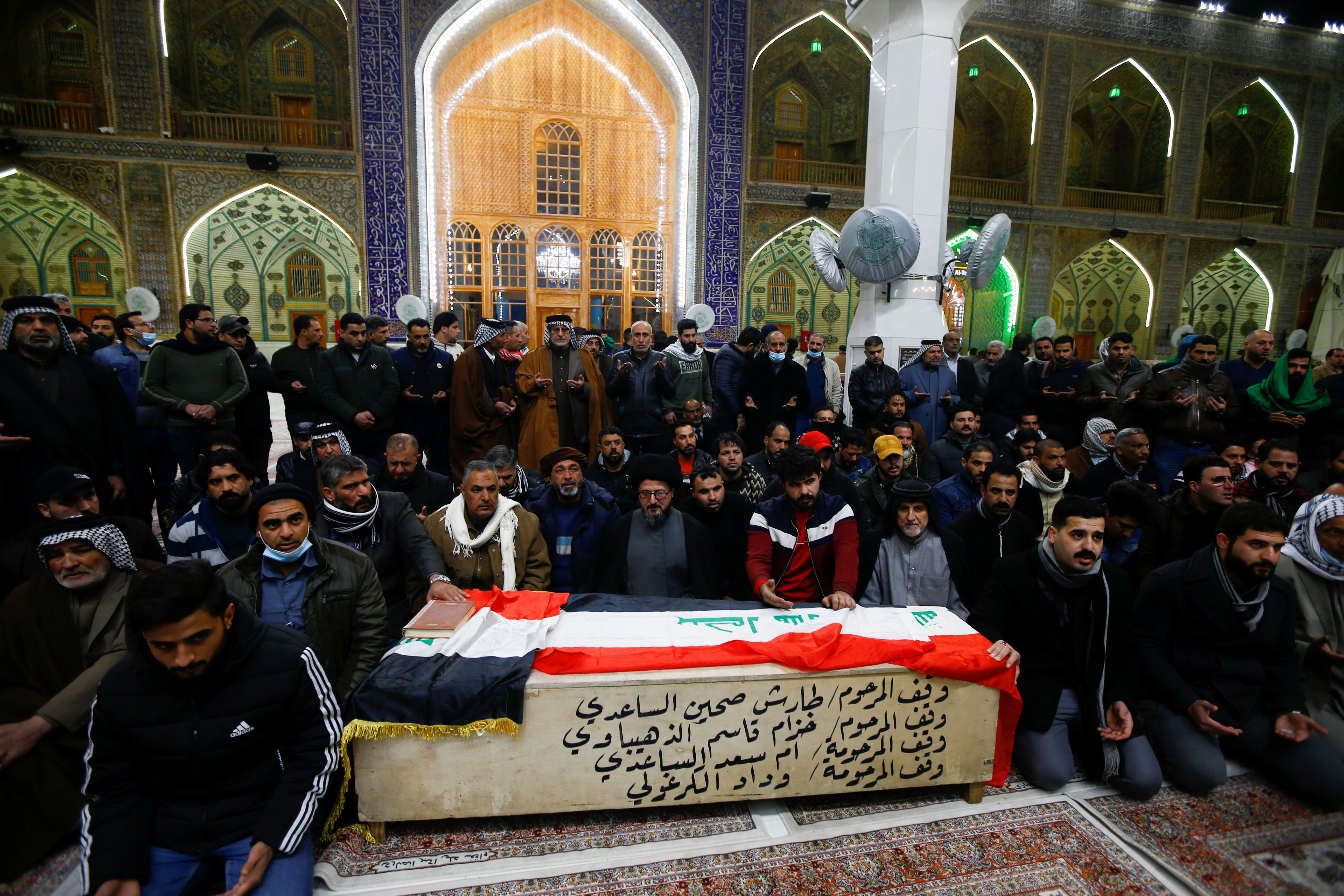Mourners gather near the coffin of a man, who was killed in a twin suicide bombing attack in a central Baghdad market, during a funeral in Najaf, Iraq [Alaa Al-Marjani/Reuters]