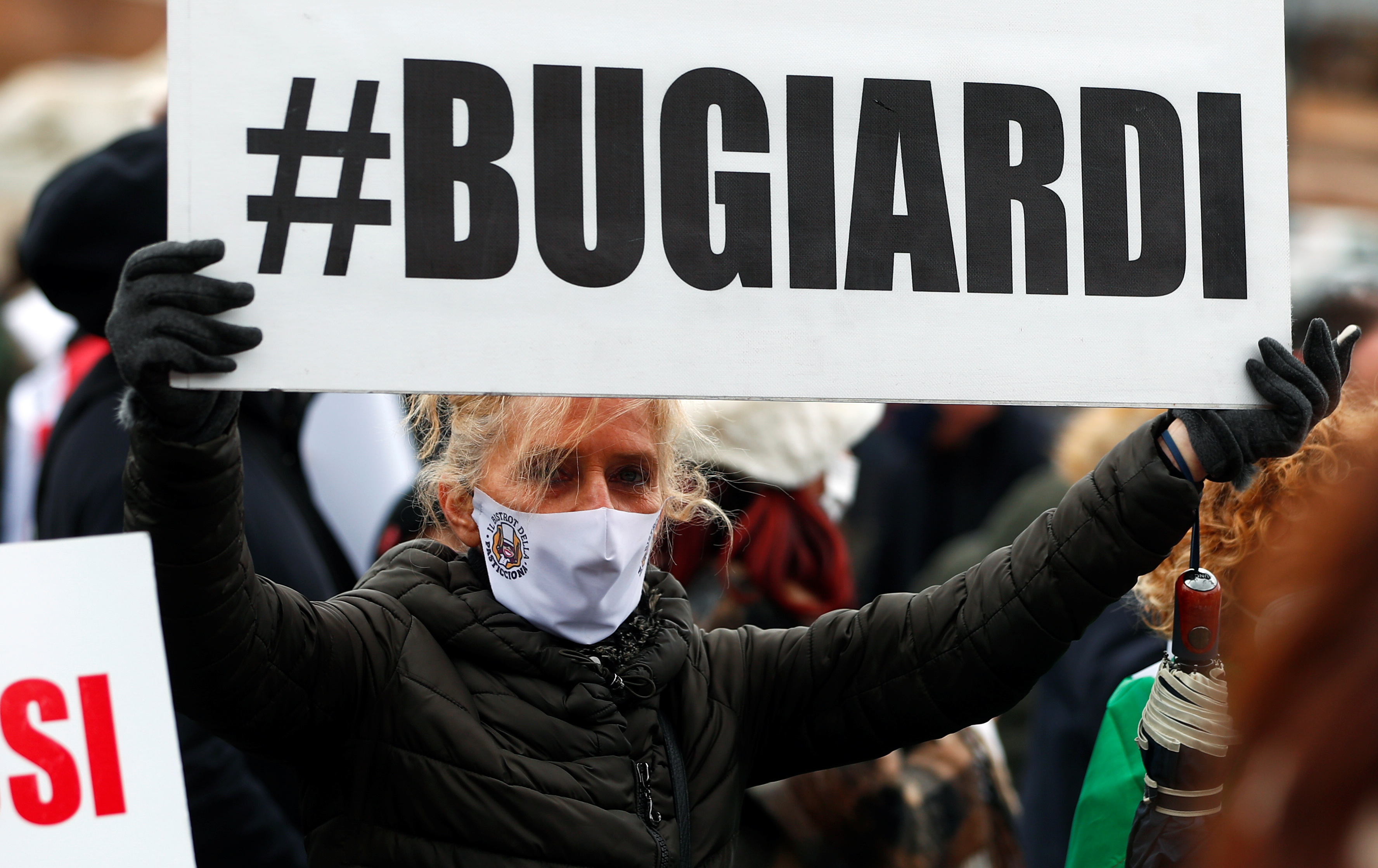 A demonstrator holds a placard that reads ‘Liars’ during a protest held by business owners against the restrictive measures put in place to fight the coronavirus disease (COVID-19) infections