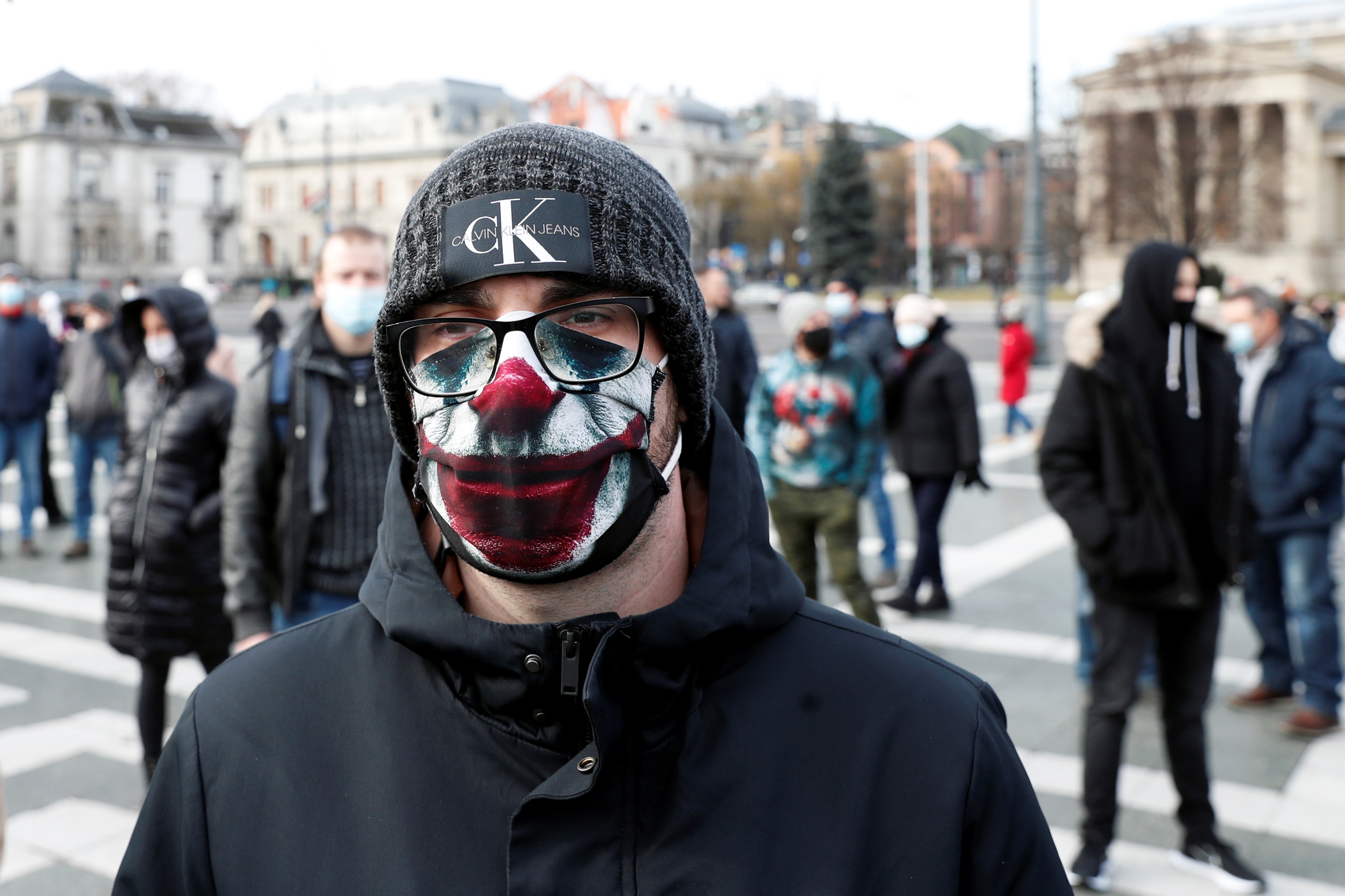 A person wearing a face mask attends a demonstration against the coronavirus disease (COVID-19) measures in Budapest