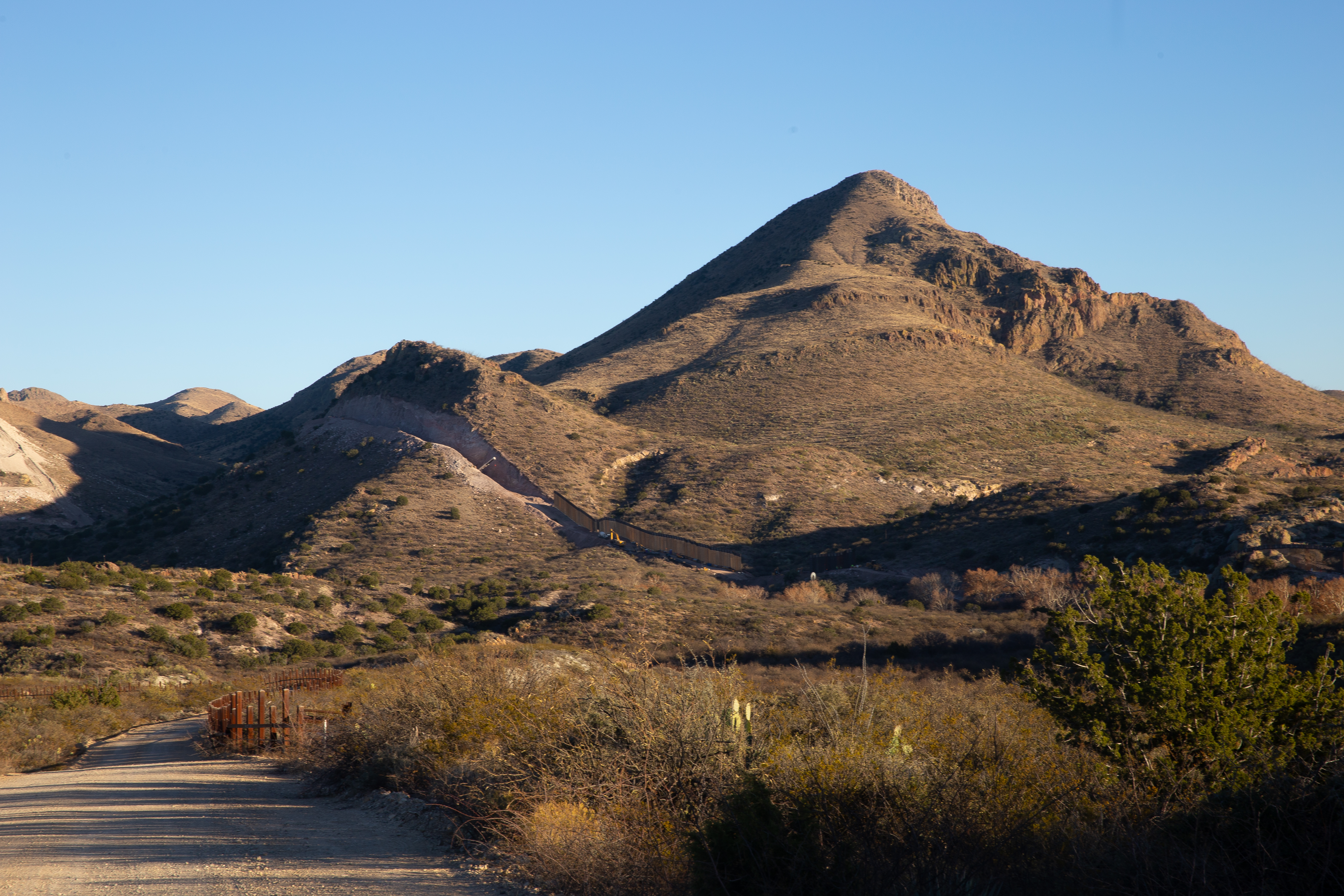 Tractors and bulldozers construct a border wall in a passage blasted through Guadalupe Canyon with dynamite in southeastern Arizona on January 8, 2021