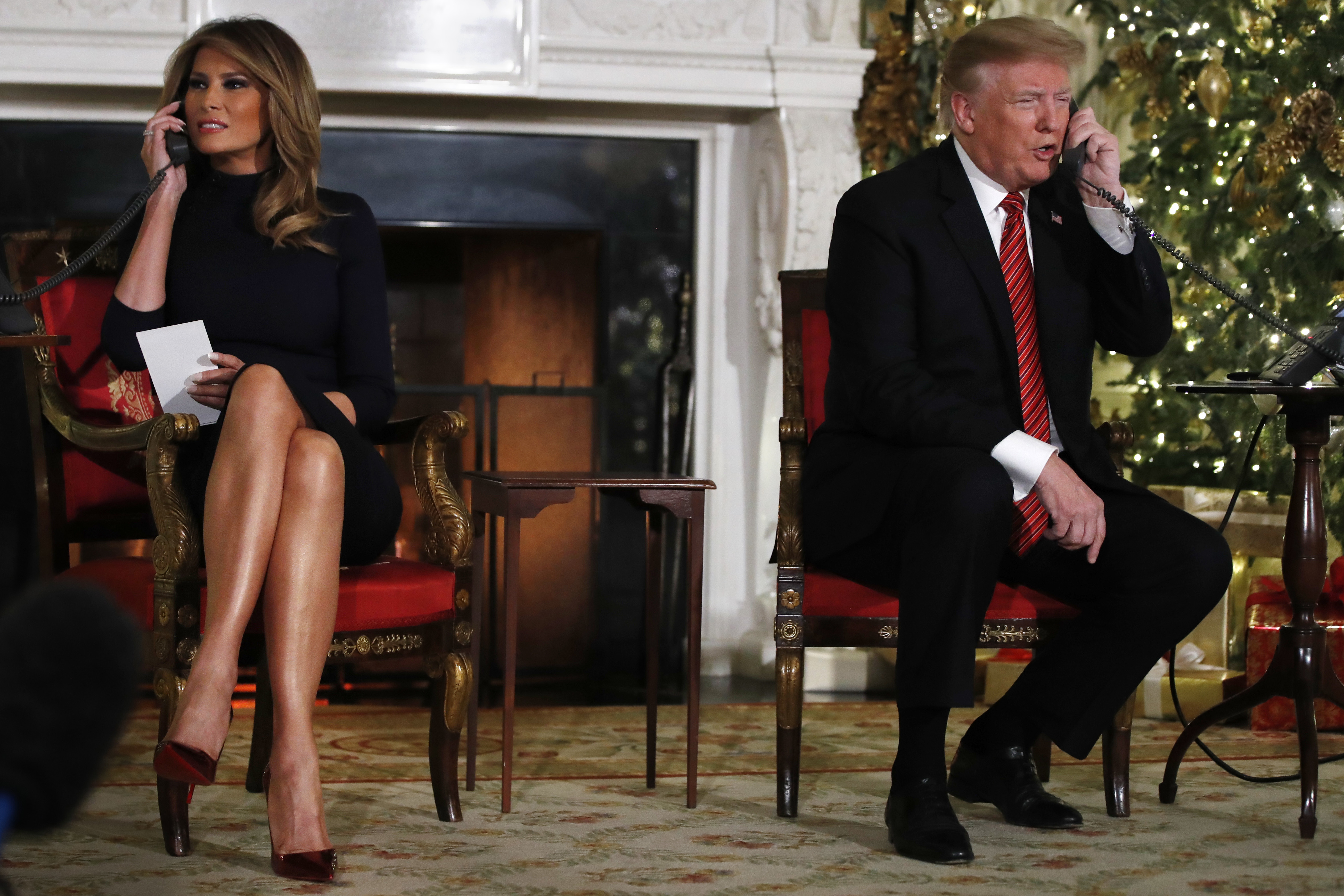 President Donald Trump and first lady Melania Trump both speak on the phone while sharing updates to track Santa’s movements from the North American Aerospace Defense Command (NORAD) Santa Tracker on December 24, 2018