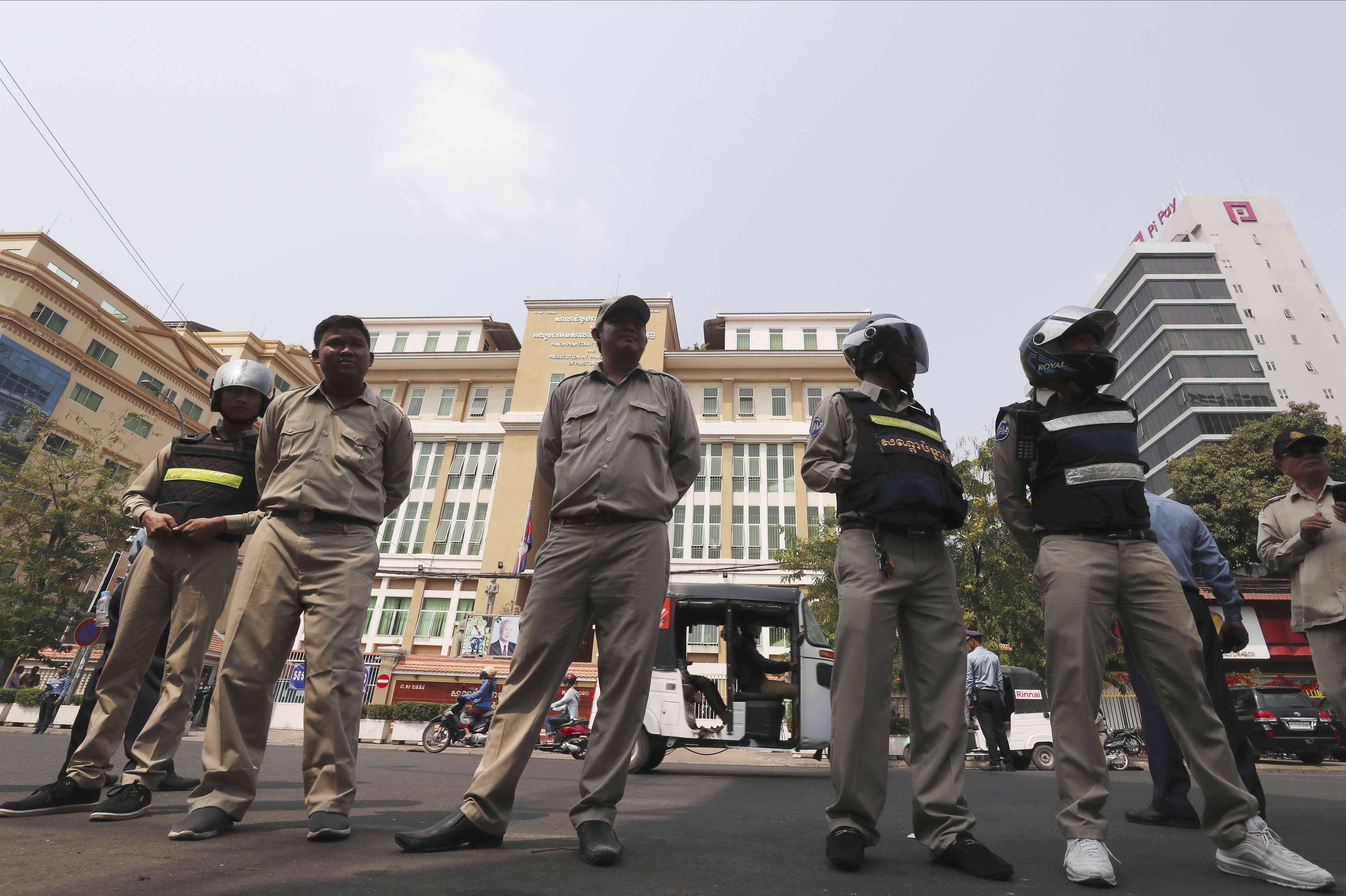 Cambodian police officers stand guard in front of the Phnom Penh Municipal Court during a hearing of opposition leader Kem Sokha, the head of the dissolved Cambodia National Rescue Party, in Phnom Penh on January 16, 2020 [File: Heng Sinith/AP Photo]