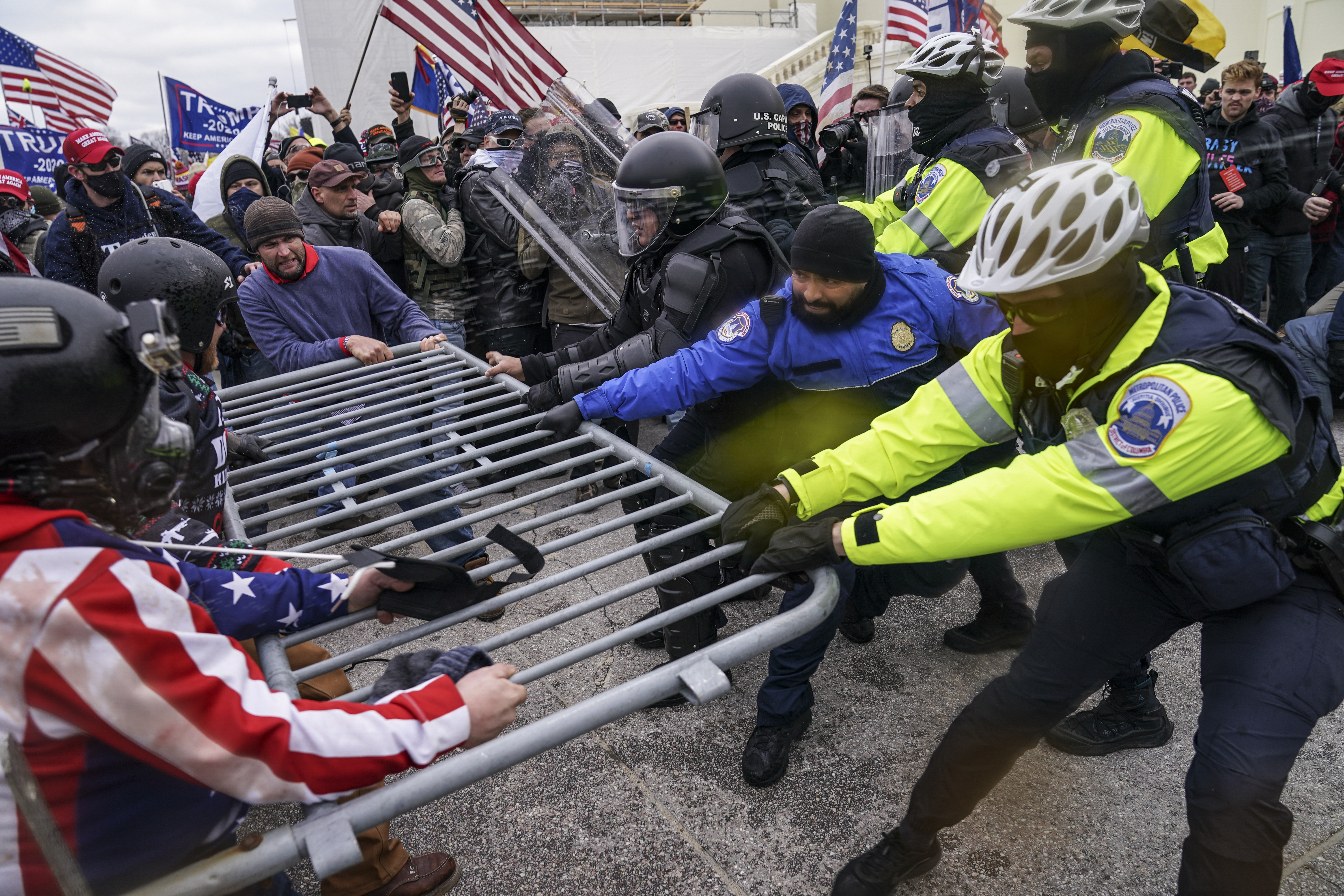 Trump supporters try to break through a police barrier, Wednesday, January 6, 2021, at the Capitol in Washington, DC