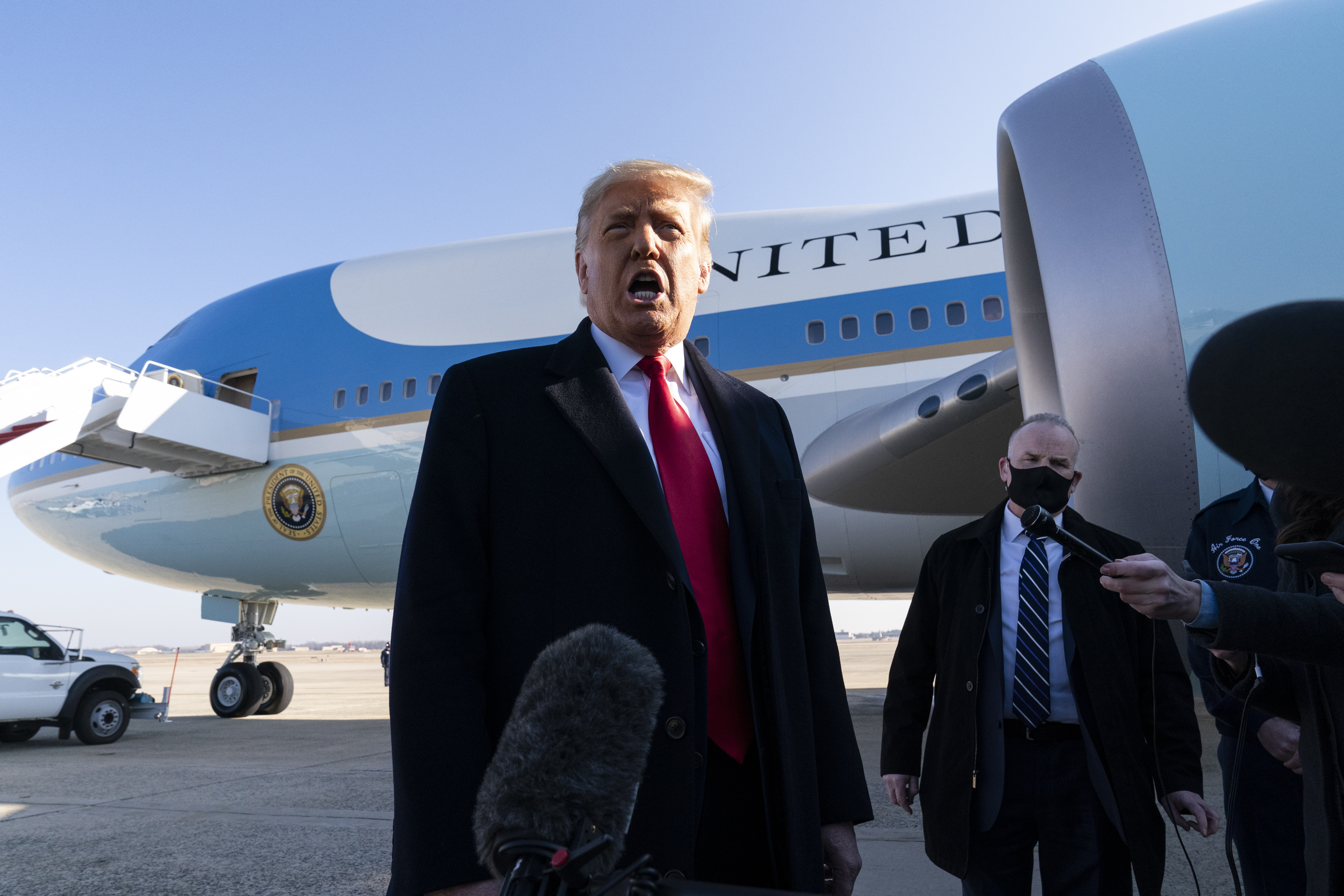 President Donald Trump speaks with reporters as he walks to Air Force One at Andrews Air Force Base, Maryland on January 12, 2021