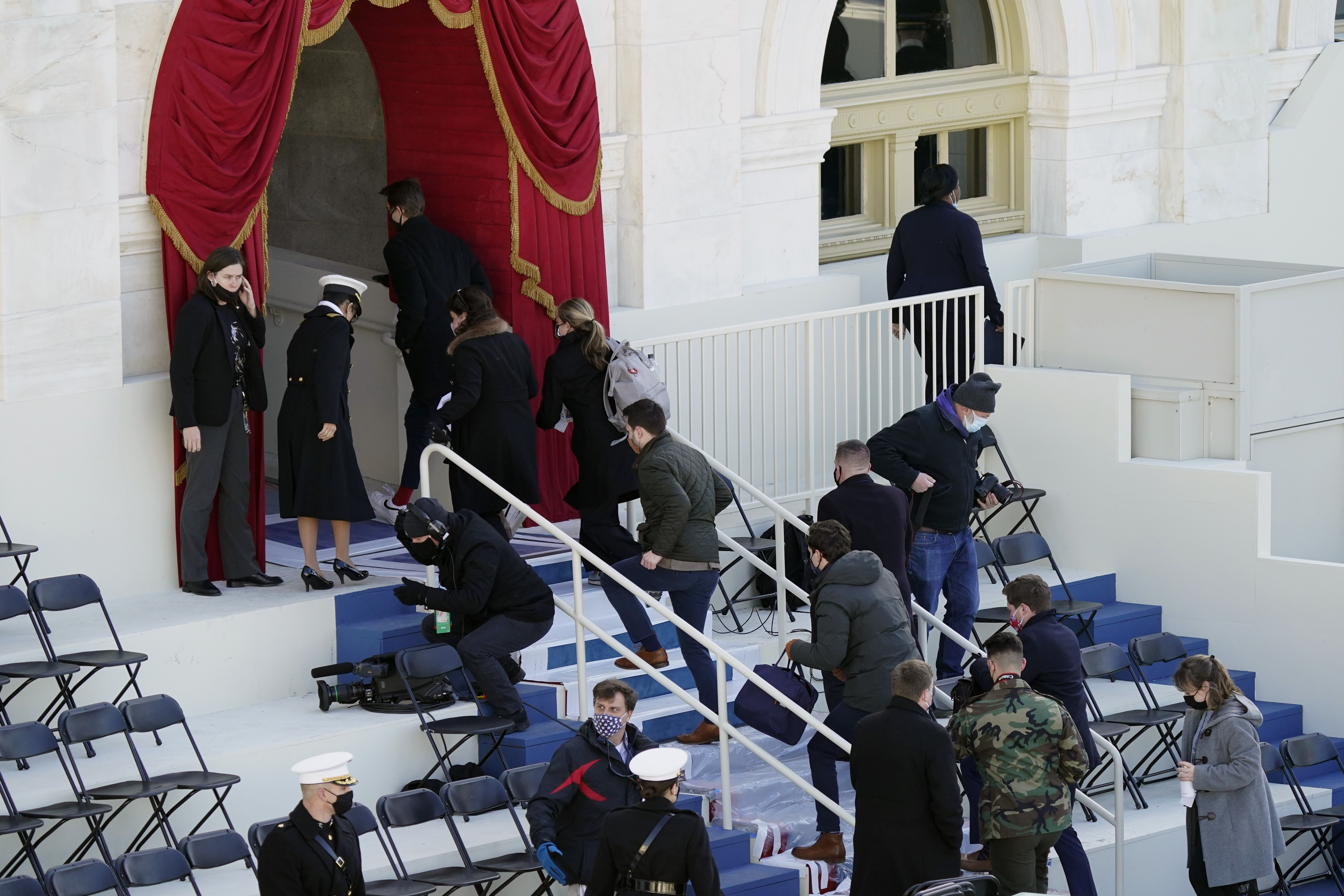 People evacuating from the West Front of the US Capitol during a rehearsal of the 59th Presidential Inauguration at the US Capitol in Washington, DC