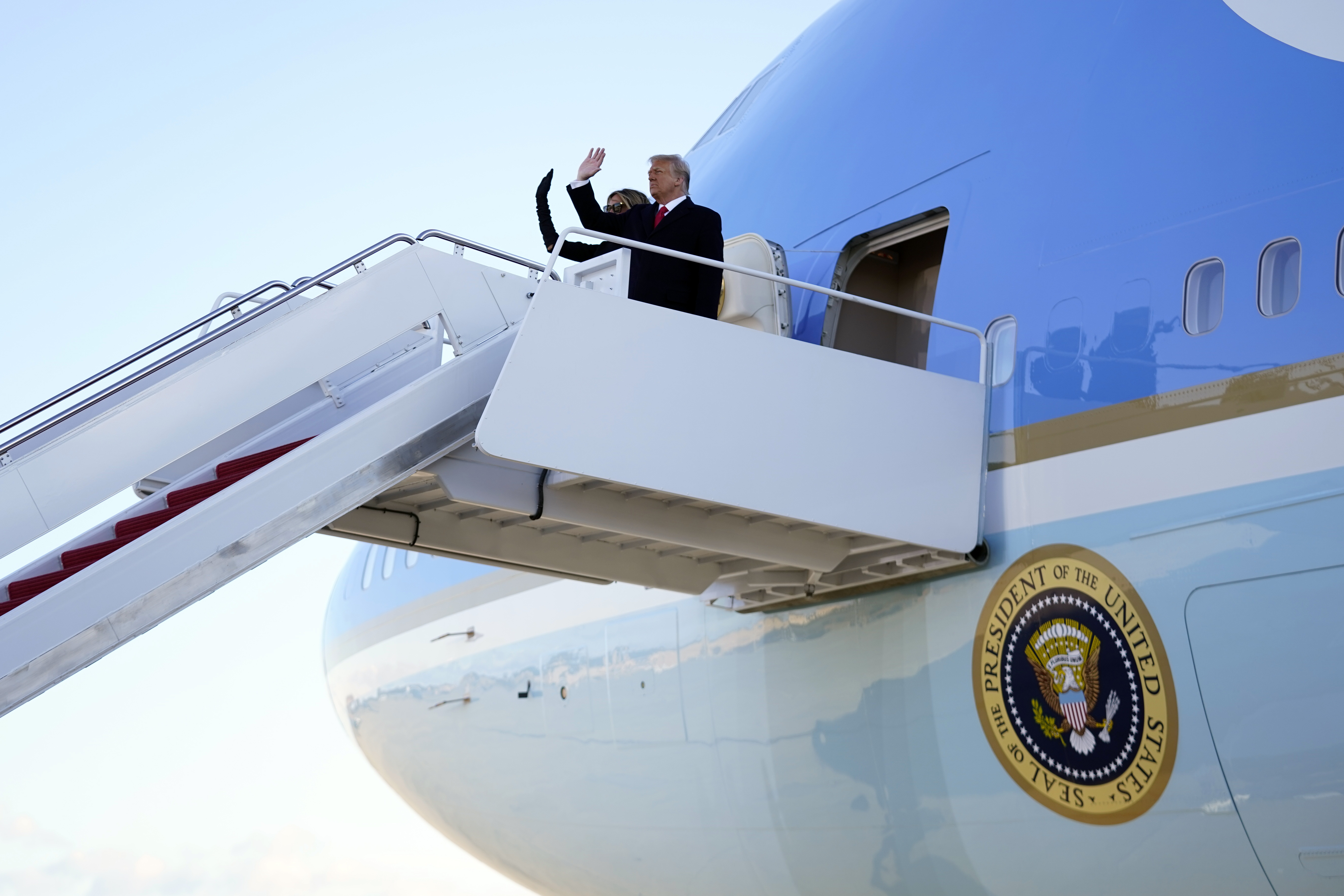 President Donald Trump and first lady Melania Trump board Air Force One at Andrews Air Force Base