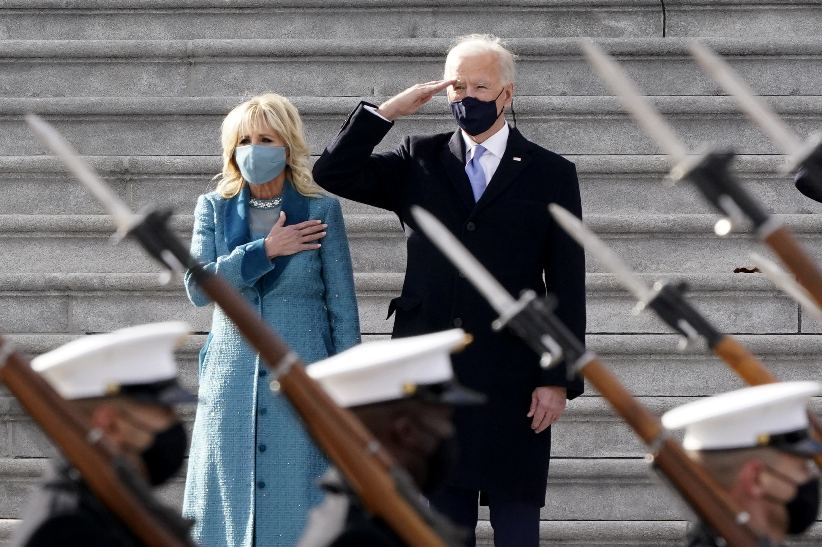 President Biden and his wife Dr Jill Biden watch a military pass in review ceremony on the East Front of the Capitol