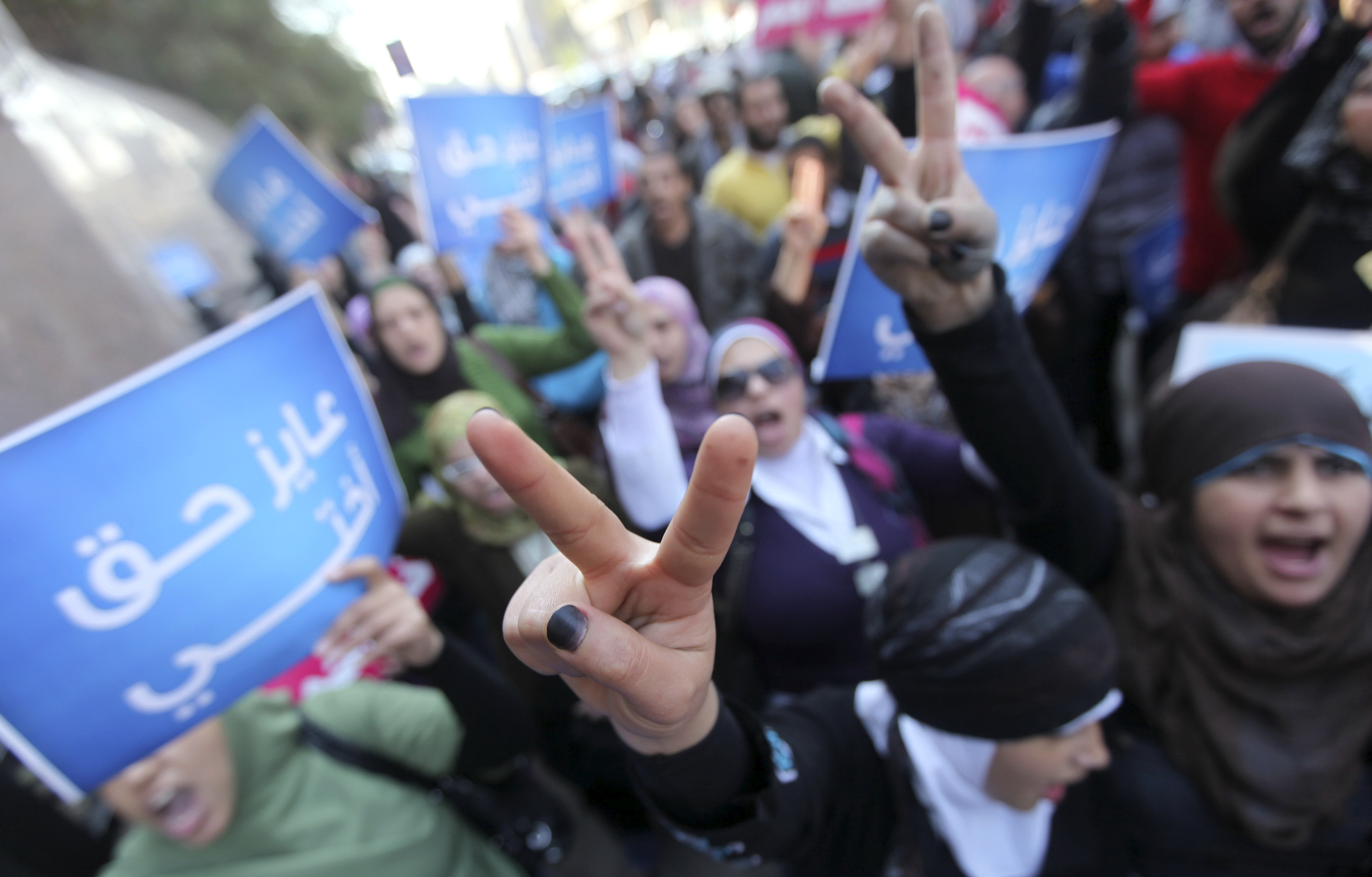 Women chant anti-military council slogans and flash victory signs as they protest against military council violations and virginity tests against females outside the State Council court and in support of activist Samira Ibrahim in Cairo, Egypt in 2011