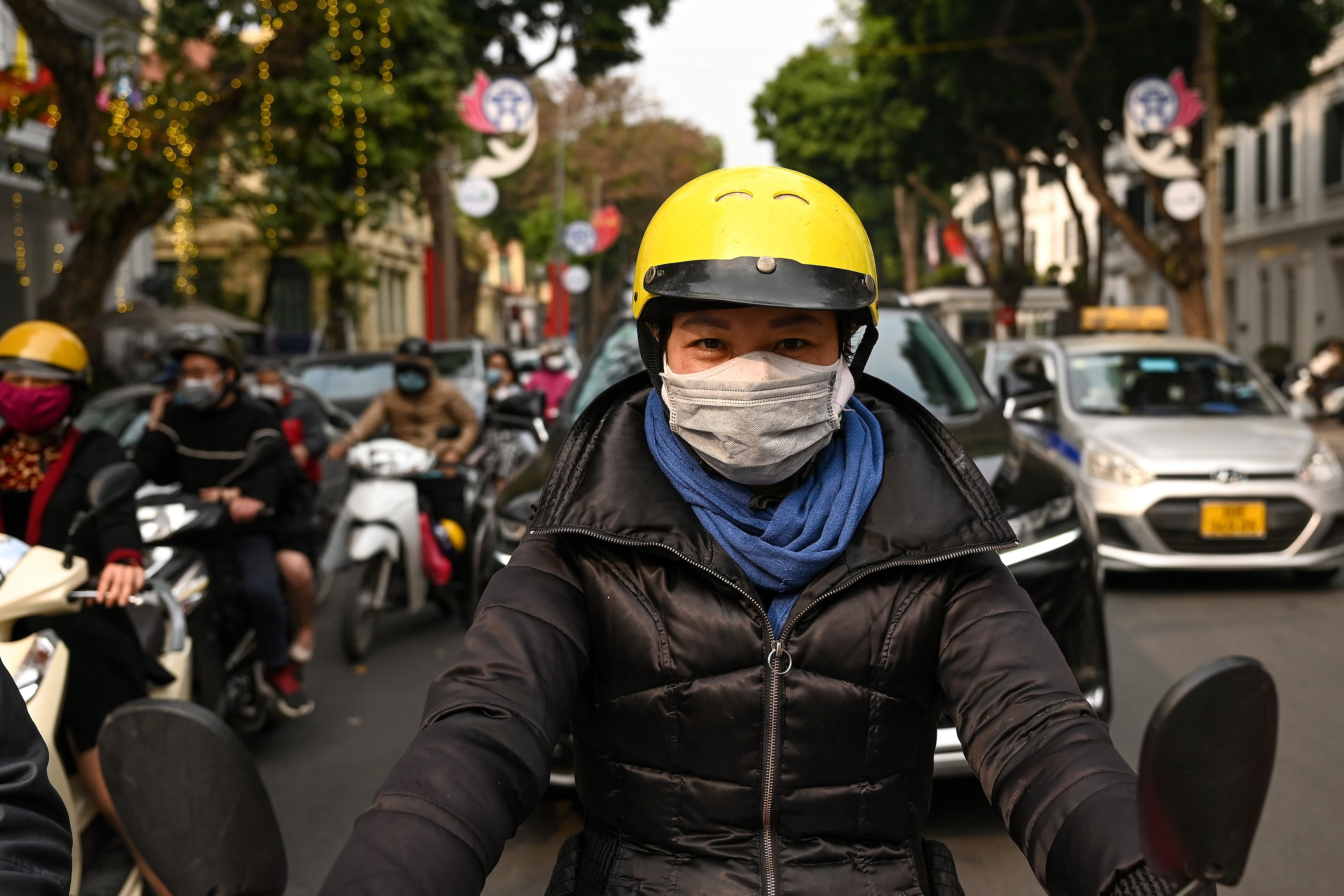 A woman wears double protective face masks to prevent the spread of COVID-19 in Hanoi on January 29, 2021, a day after Vietnam recorded its first coronavirus outbreak in almost two months