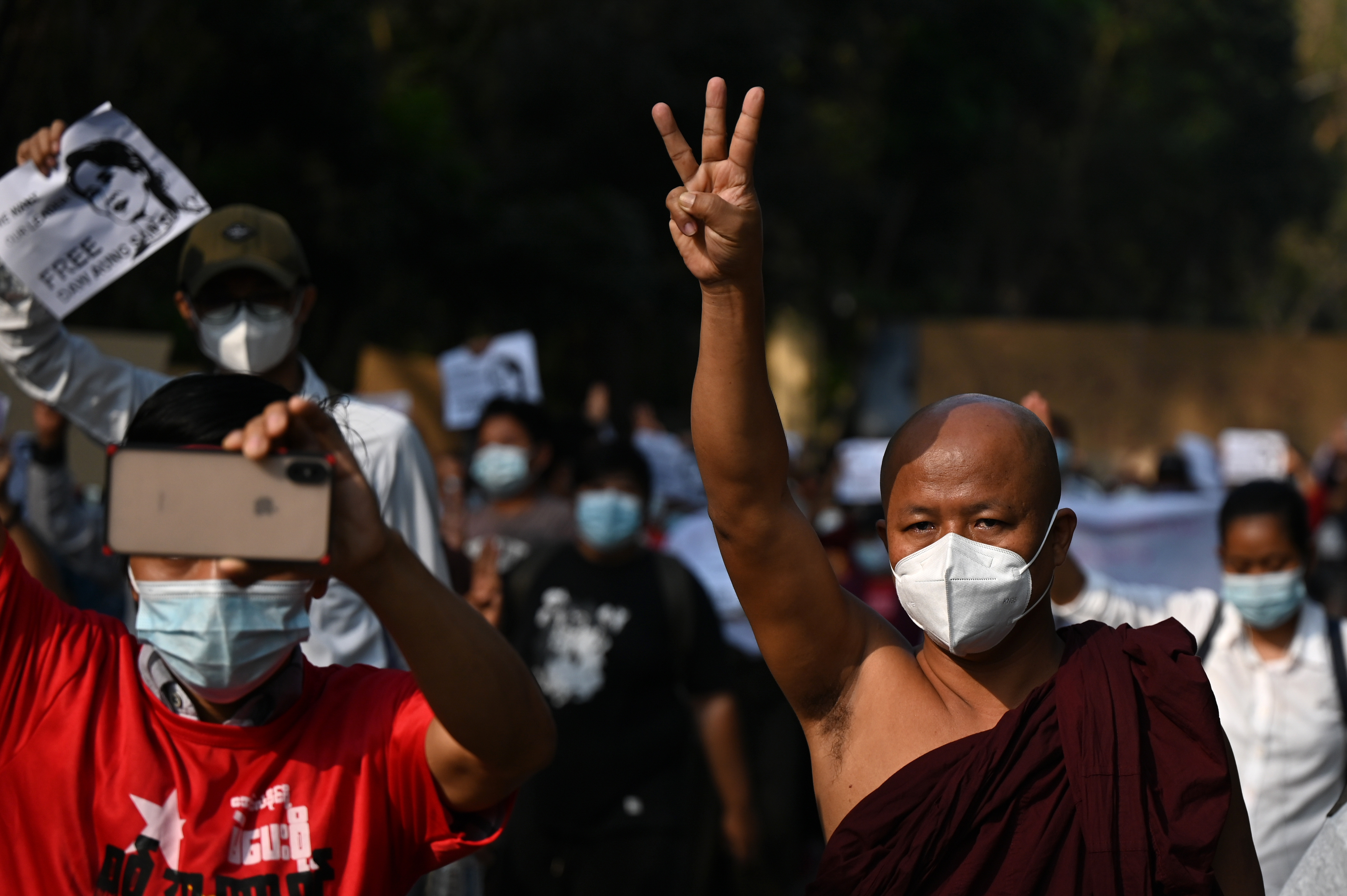 A monk raises the three-finger salute during a protest against the military coup in Yangon on February 7, 2021