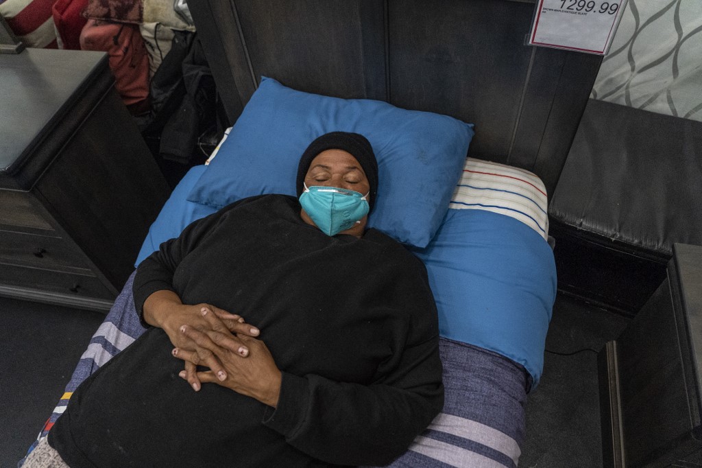 A resident of Houston, Texas take shelter at a furniture store, which opened its door and transformed into a warming station after winter weather caused electricity blackouts throughout the state