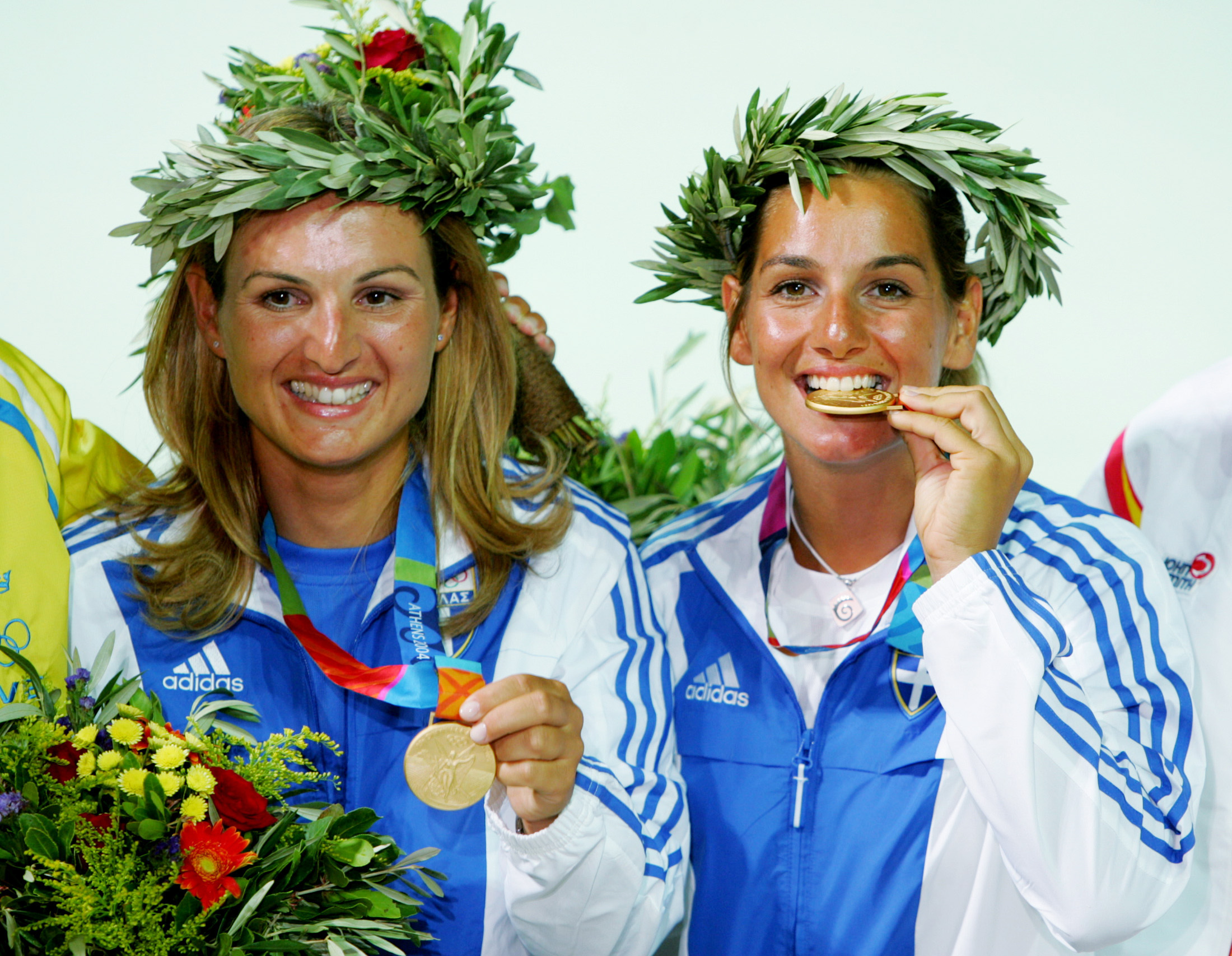 Sofia Bekatorou, left, and her sailing partner Aimilia Tsoulfa show off their gold medals at the award ceremony after the Athens Olympics in 2004