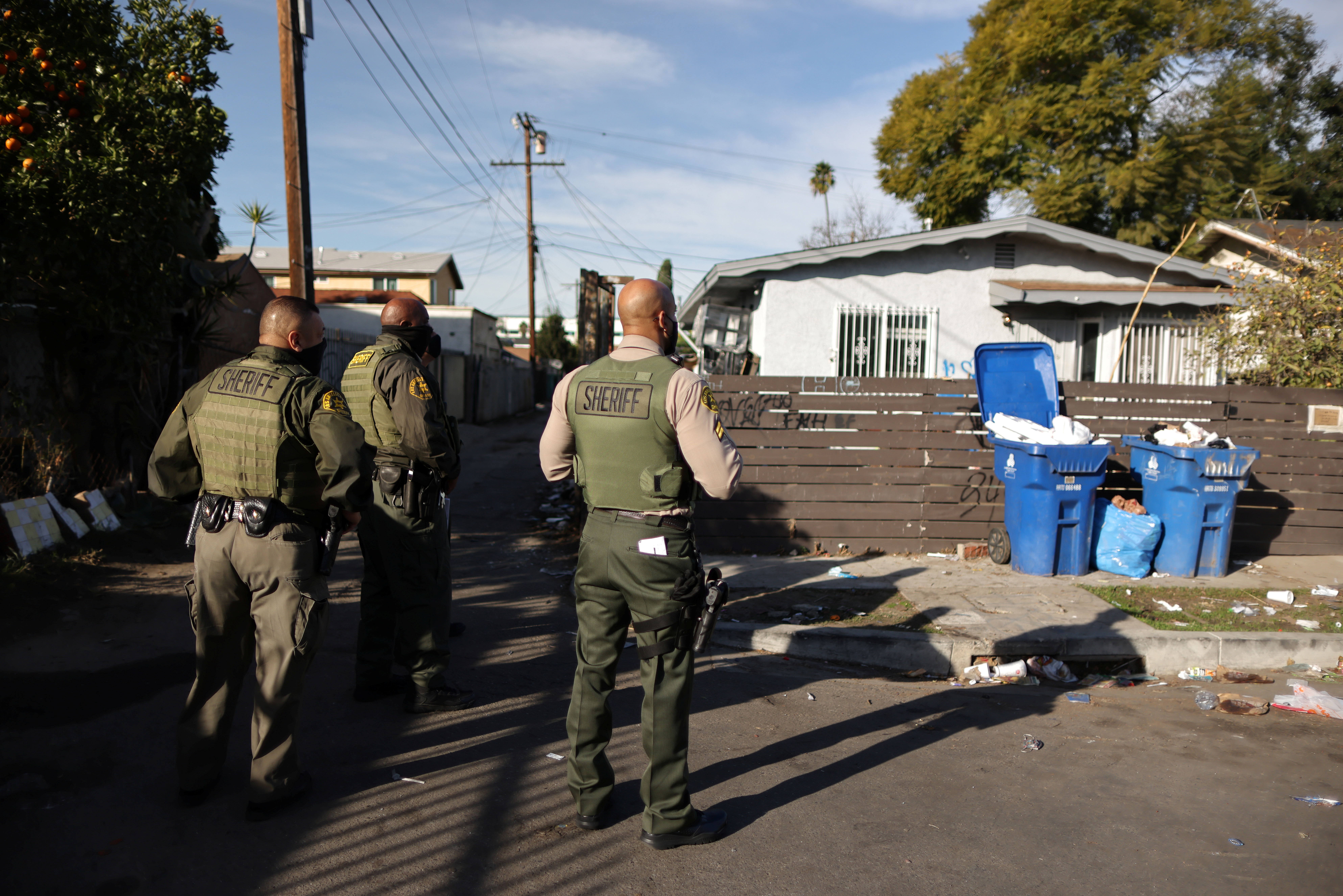 Despite the federal moratorium on evictions during the coronavirus pandemic, tenants have continued to lose homes, like this one being approached by sheriff’s deputies about to carry out an eviction in Los Angeles, California in January
