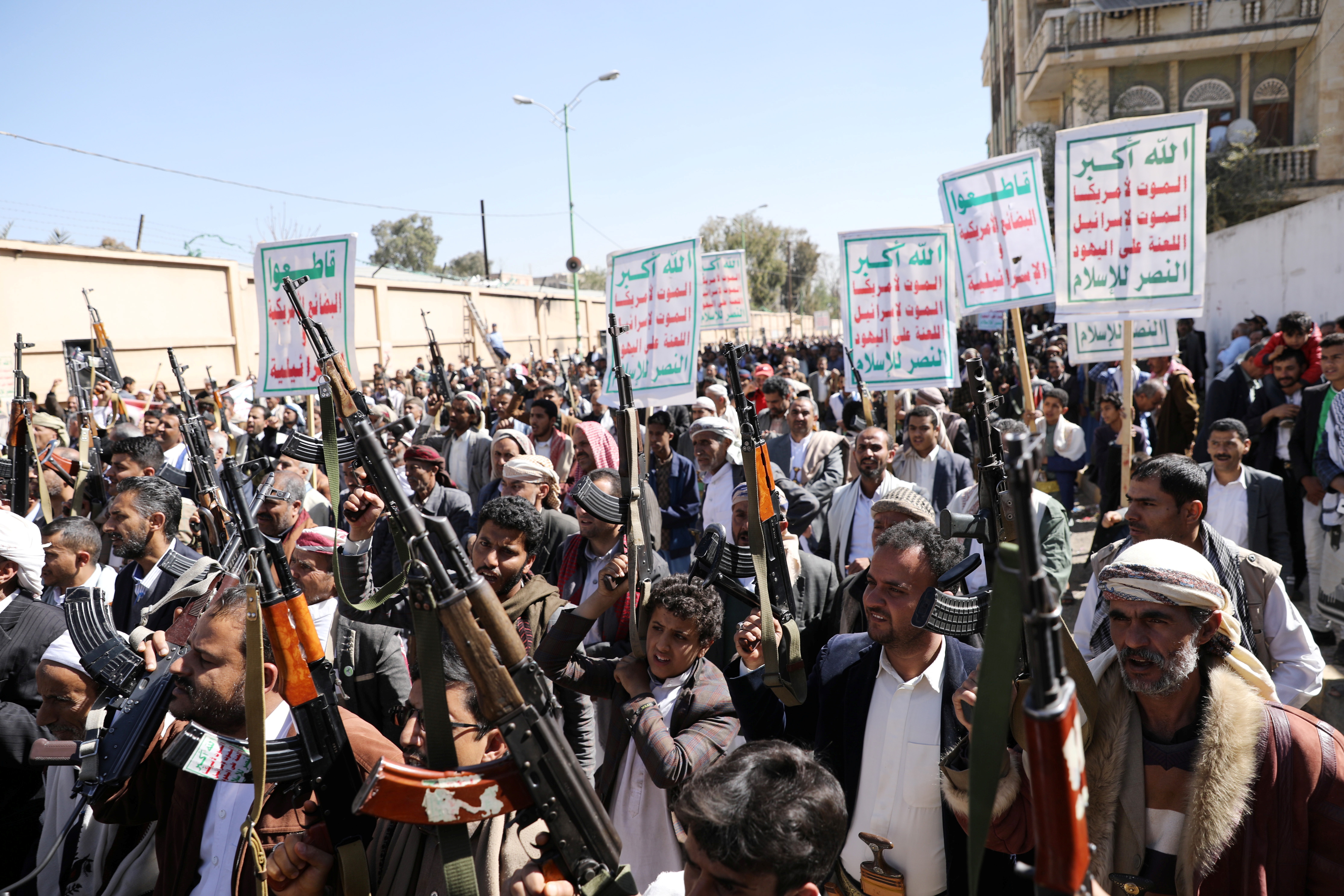 Houthi supporters hold up their weapons during a demonstration against the US decision to designate the Houthis as a foreign terrorist organisation, in Sanaa, Yemen, on January 20, 2021