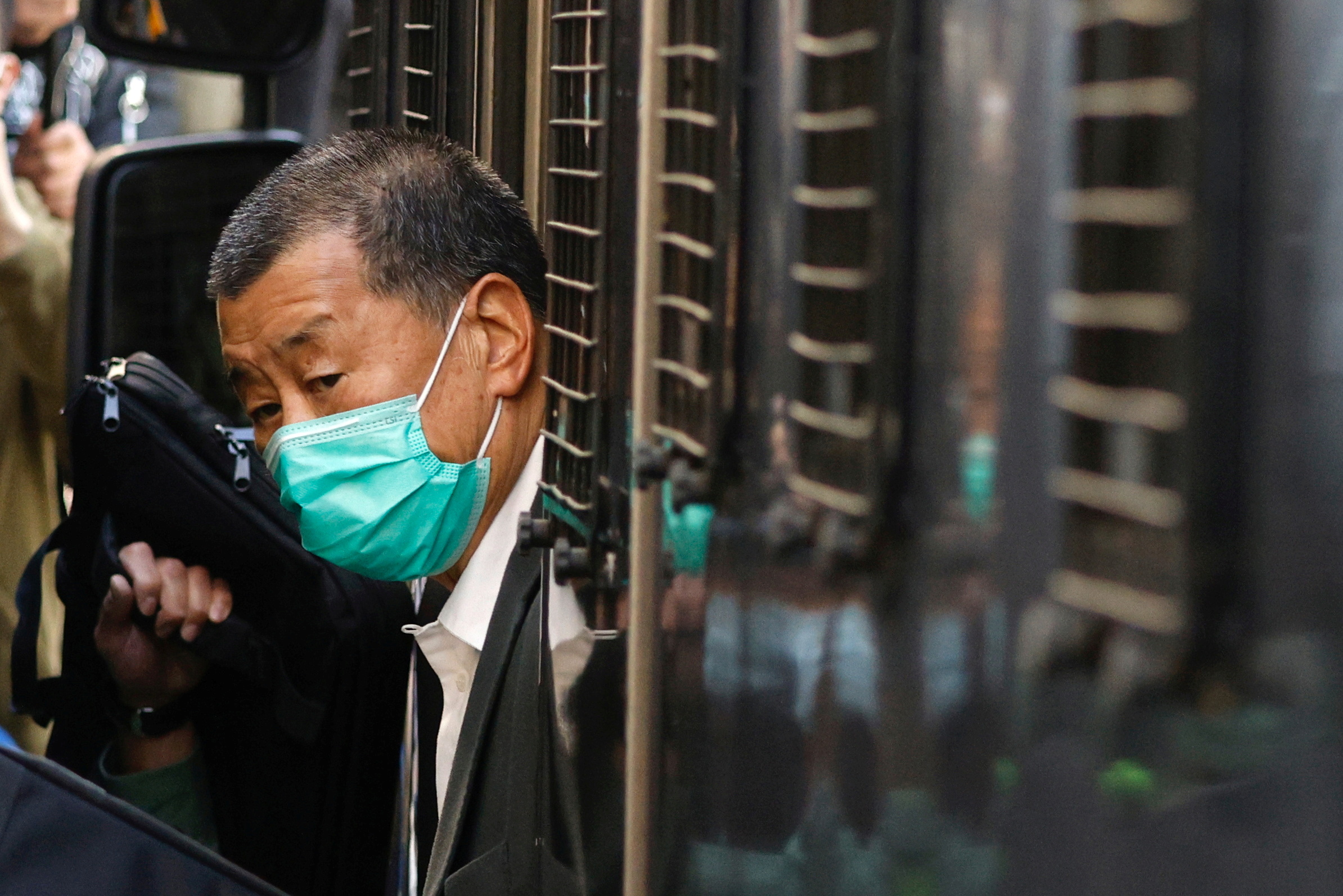 Jimmy Lai getting out of a prison van during a February 2021 court appearance [File: Tyrone Siu/Reuters]