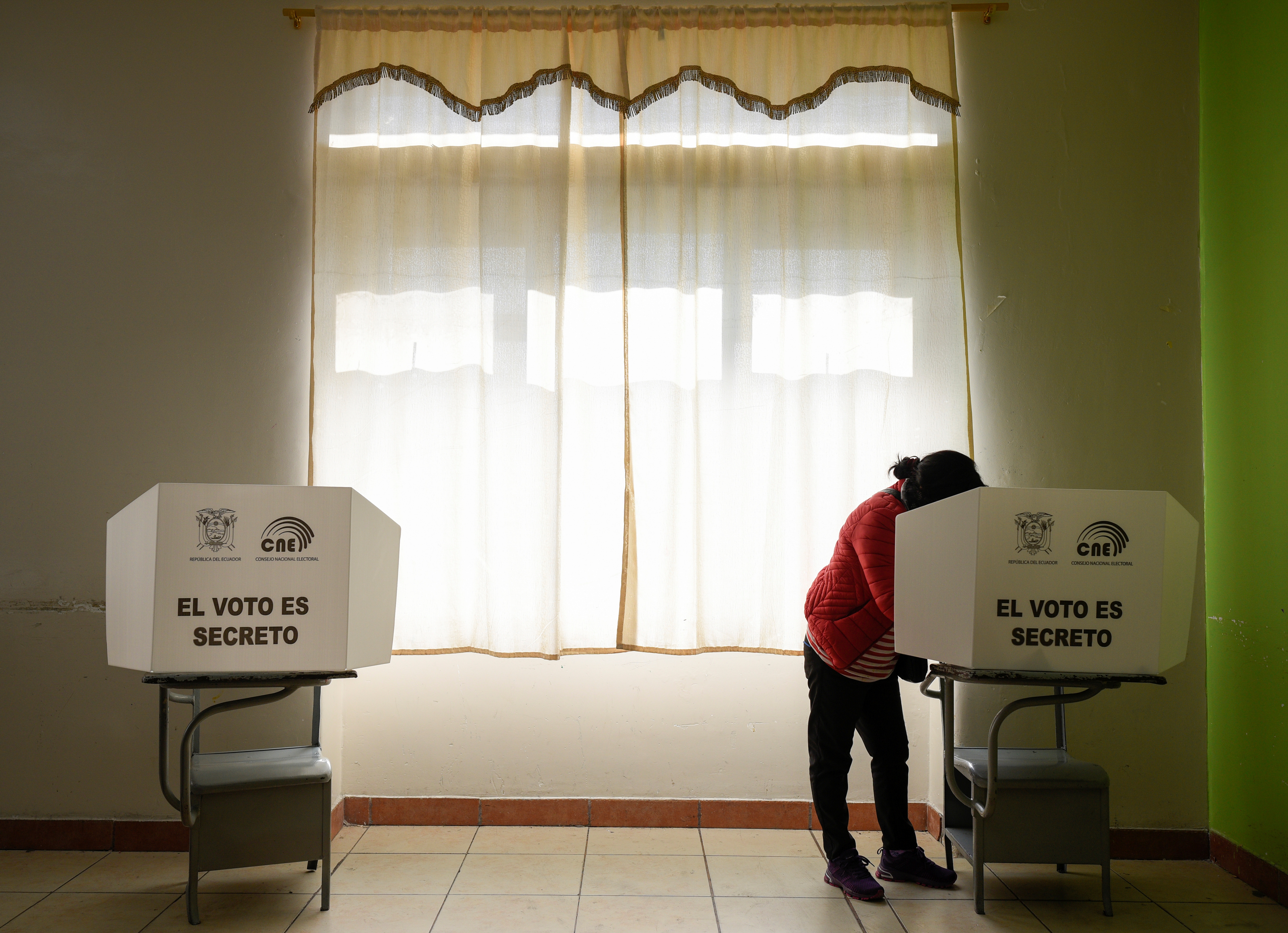 A woman casts her vote at a polling station during the presidential election, in Quito, Ecuador on February 7
