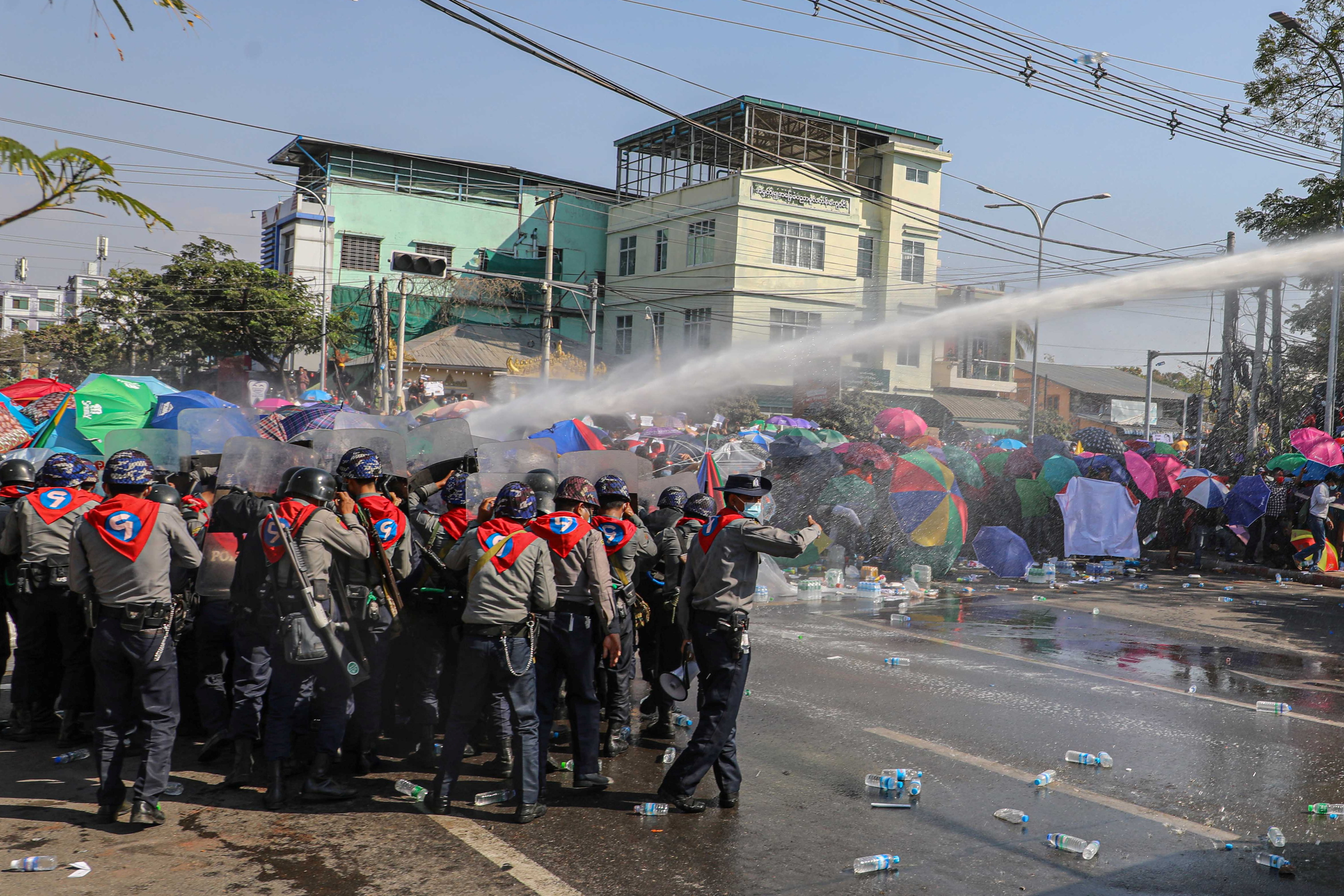 Police use a water canon against demonstrators as they protest against the military coup and to demand the release of elected leader Aung San Suu Kyi, in Mandalay, Myanmar, February 9, 2021