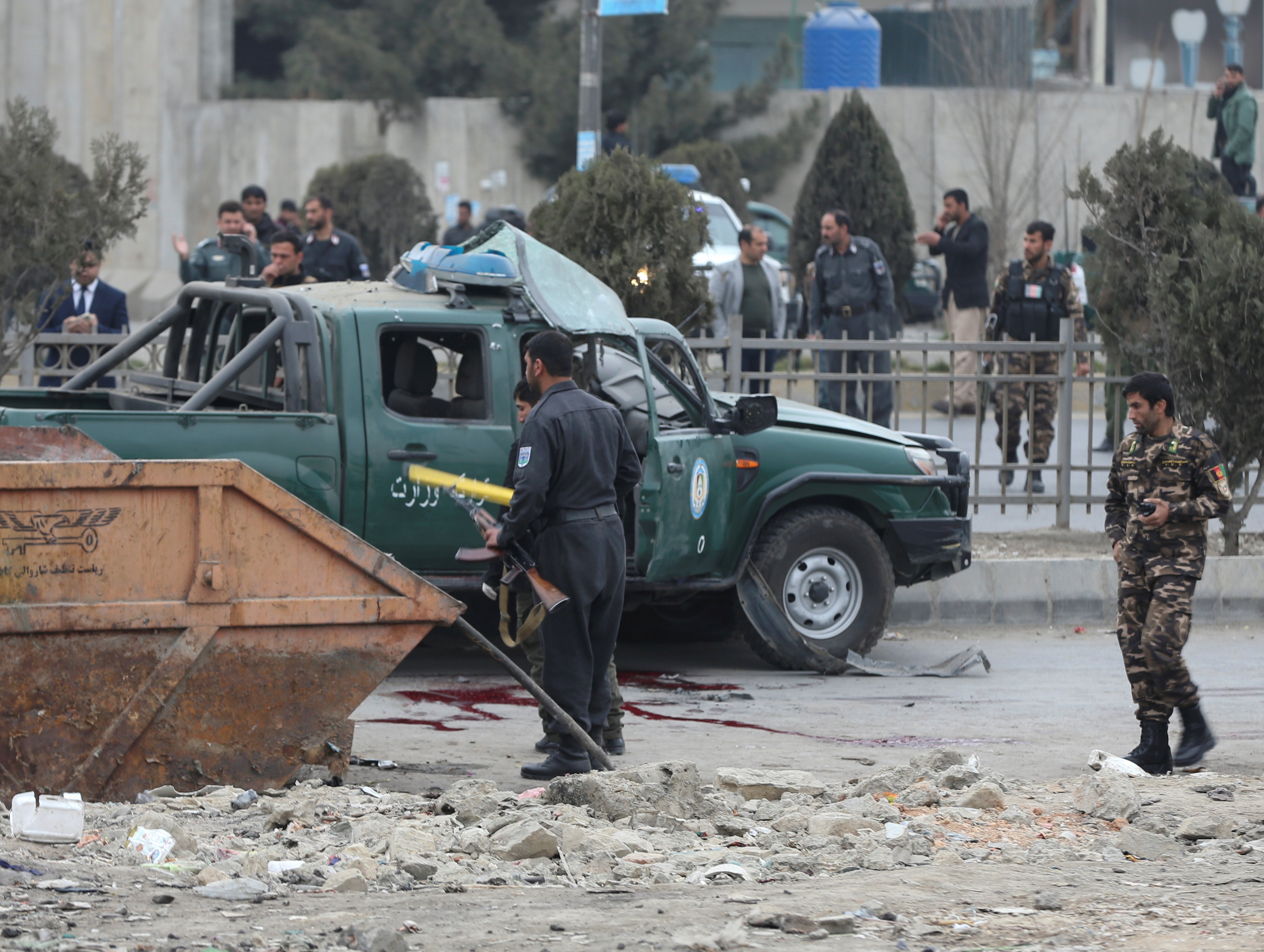 Afghan security forces inspect the site of a bomb blast in Kabul, Afghanistan, February 21, 2021