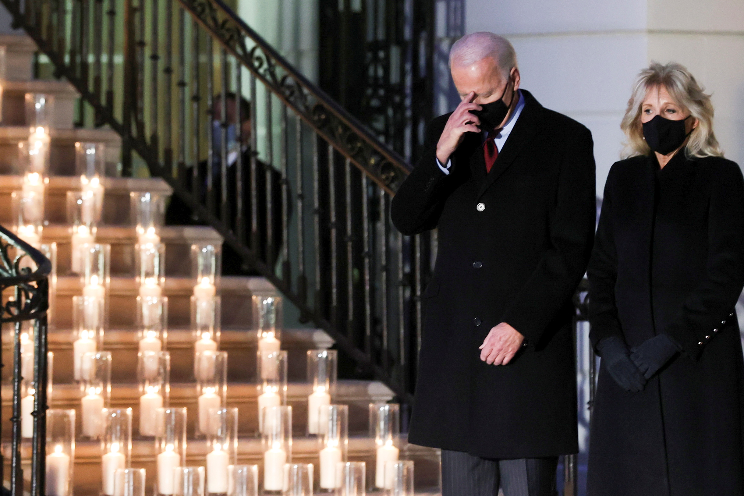 US President Joe Biden and his wife Jill Biden attend a candle lighting ceremony to commemorate the 500,000 COVID-19 deaths in the US, at the White House on February 22