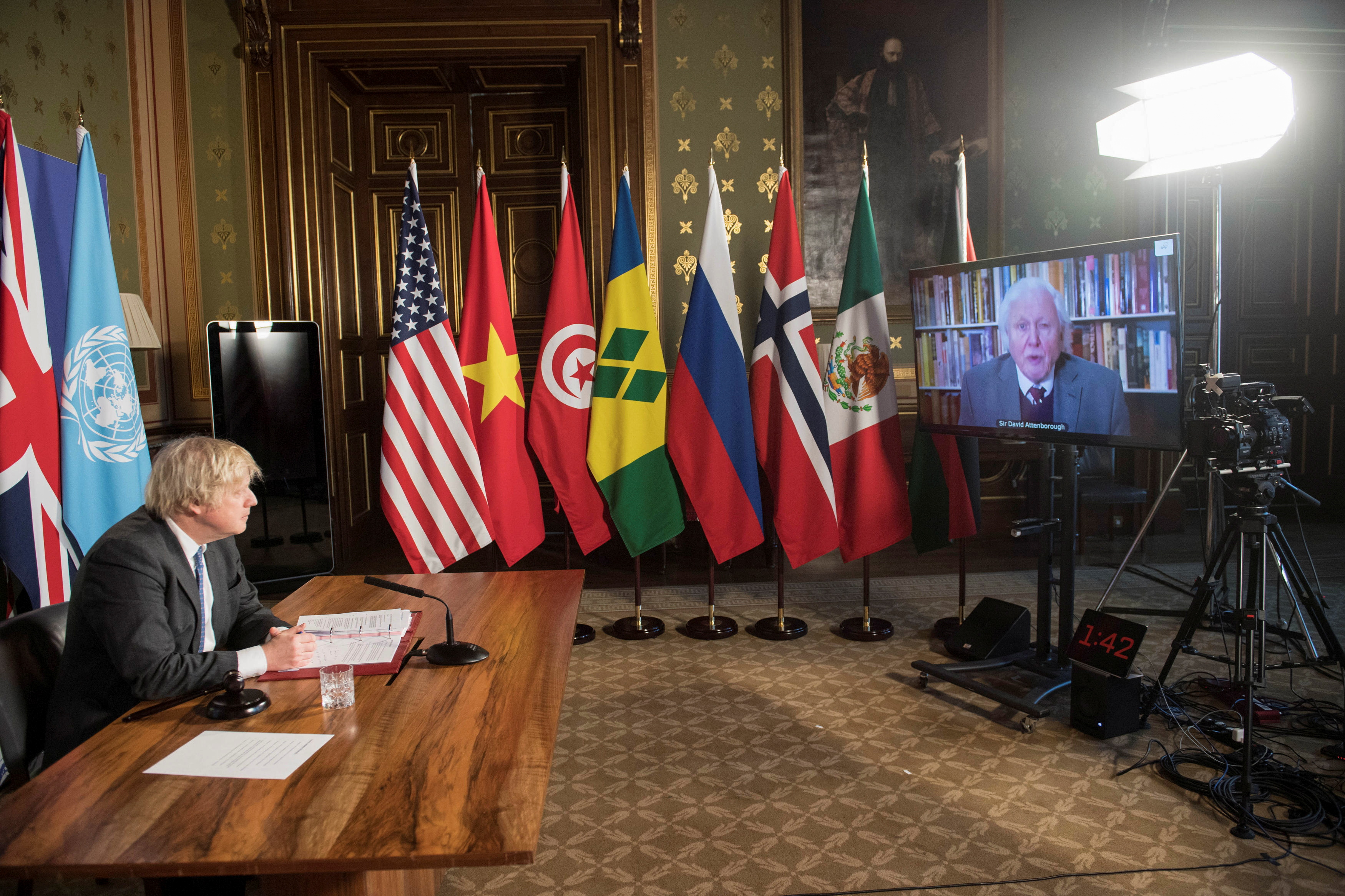 British Prime Minister Boris Johnson watches a video address by conservationist David Attenborough at a session of the UN Security Council on climate and security